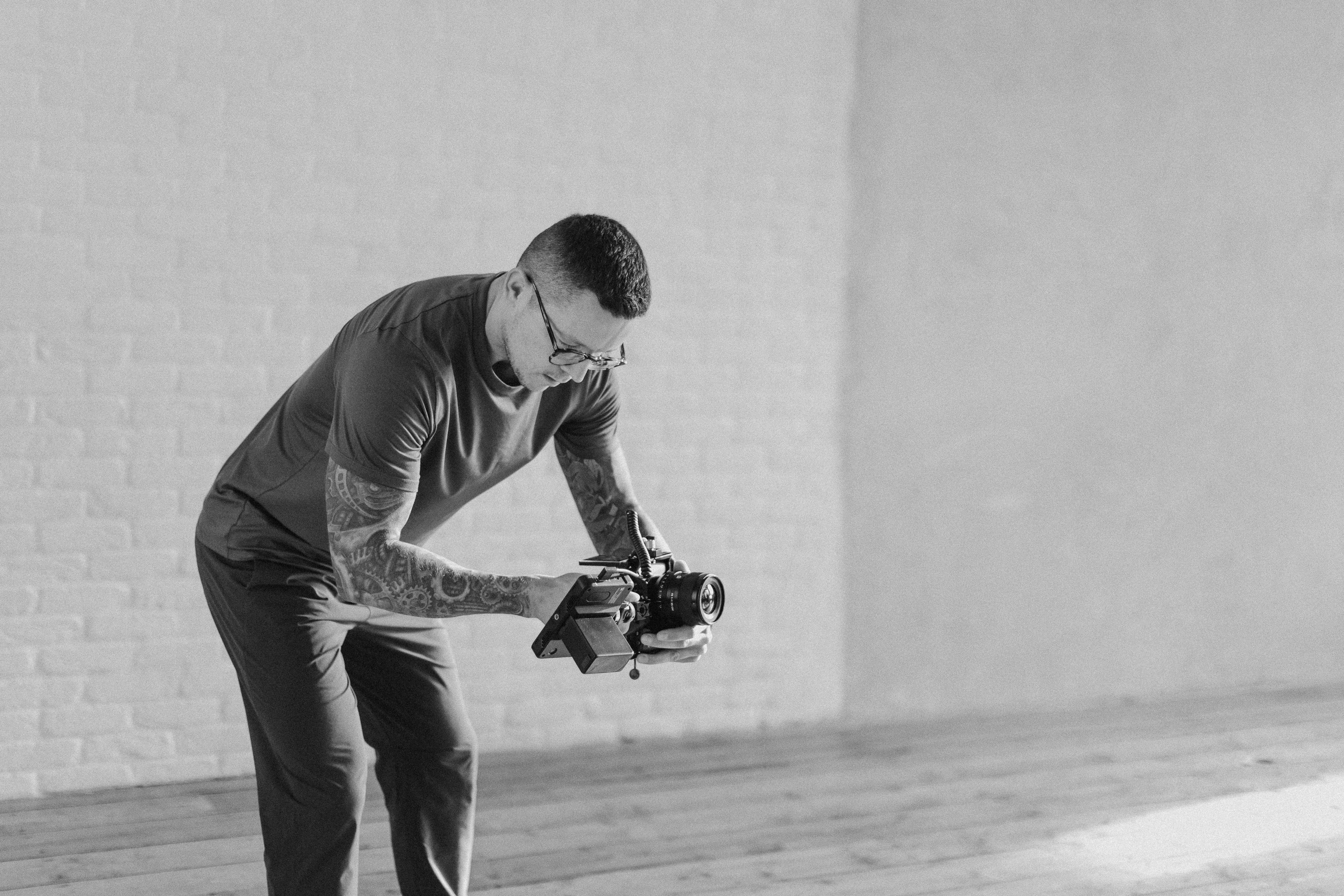 Three people sitting on a couch in a room looking at mobile devices