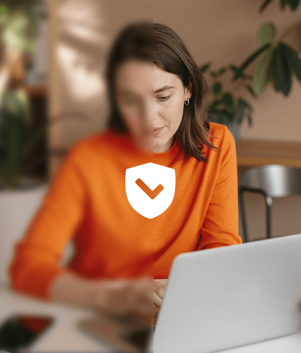 two ladies looking at a laptop and smiling