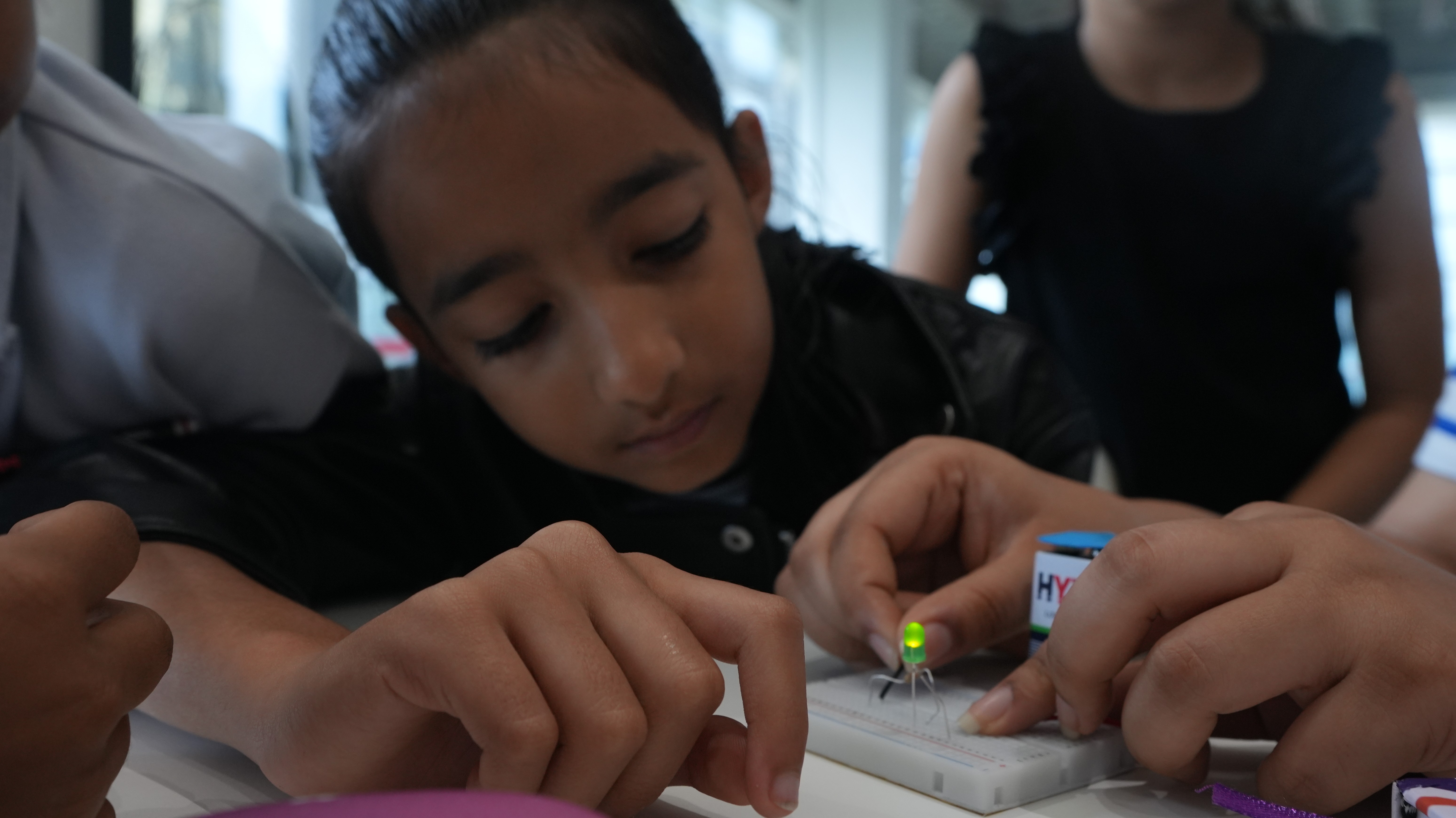 Student assembling circuit in a technical workshop