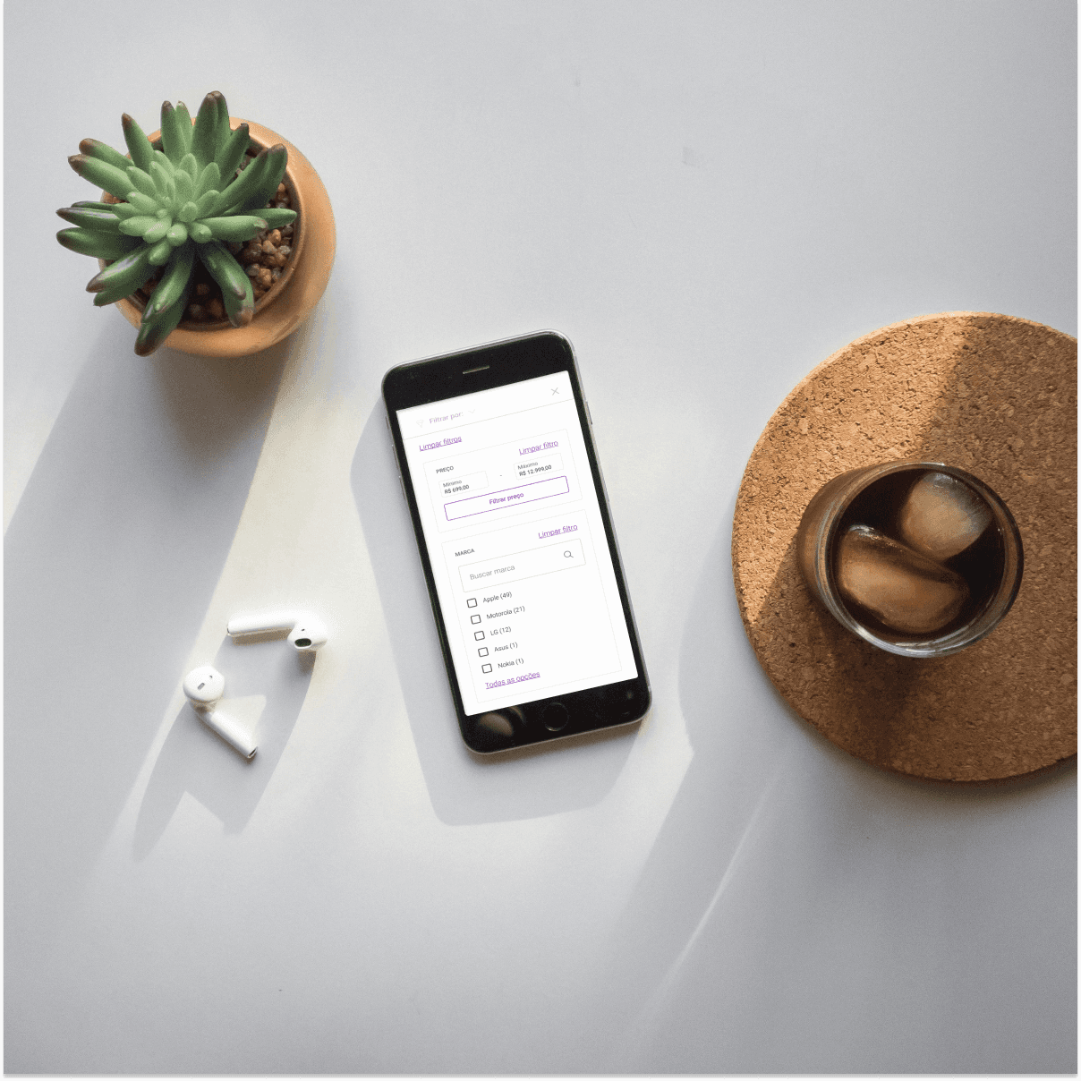 Scene with a iced coffee a plant and a smartphone with filter component on screen