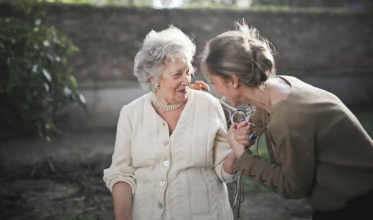 two people looking at a tablet and smiling