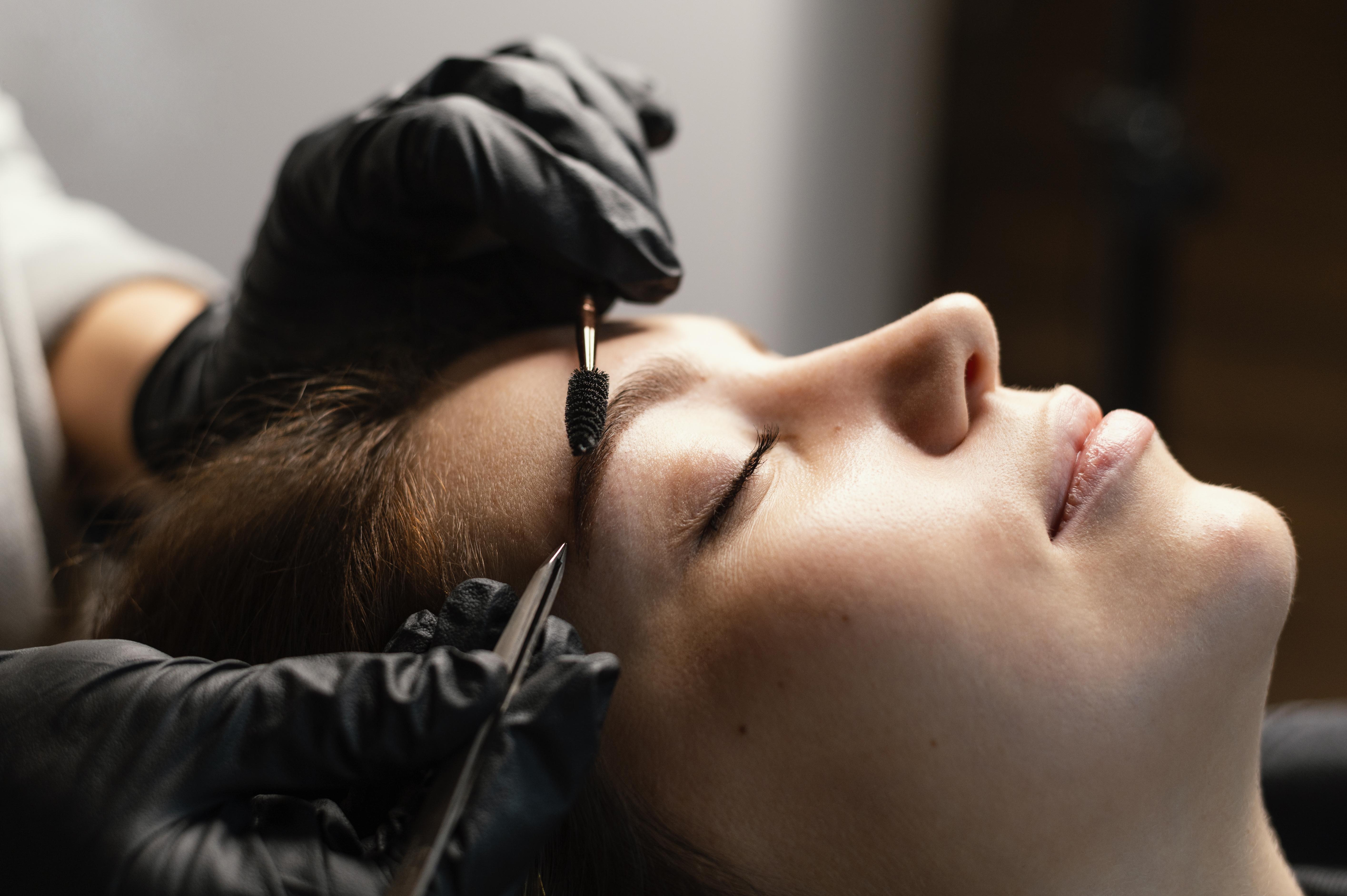 A close-up of a luxurious skincare jar with a gold lid, set against a soft, neutral background with gentle shadows.