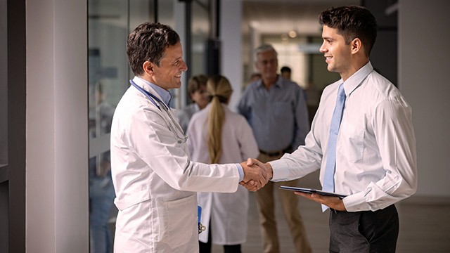 A doctor shaking a man's hand.