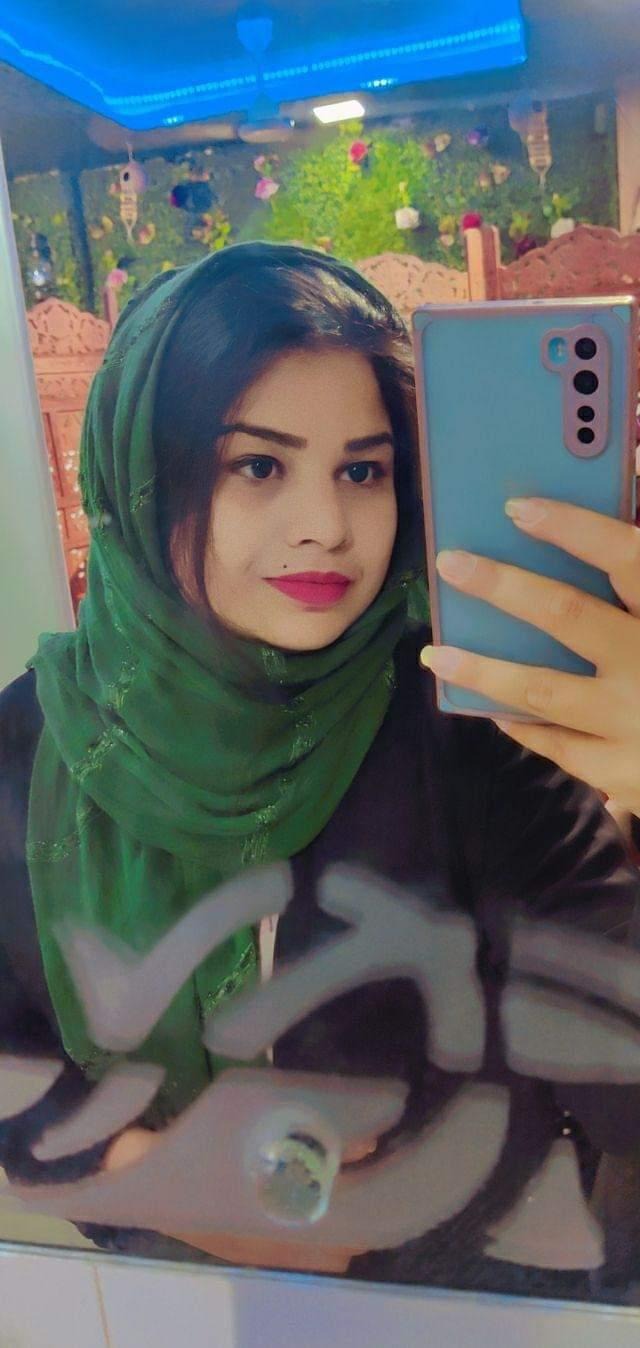 Close-up of a tree stump showing growth rings and a textured brown wood surface.