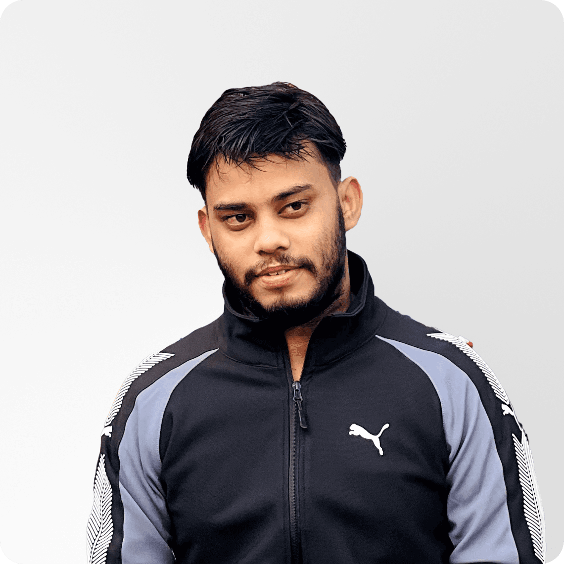 a man standing in front of a brick wall