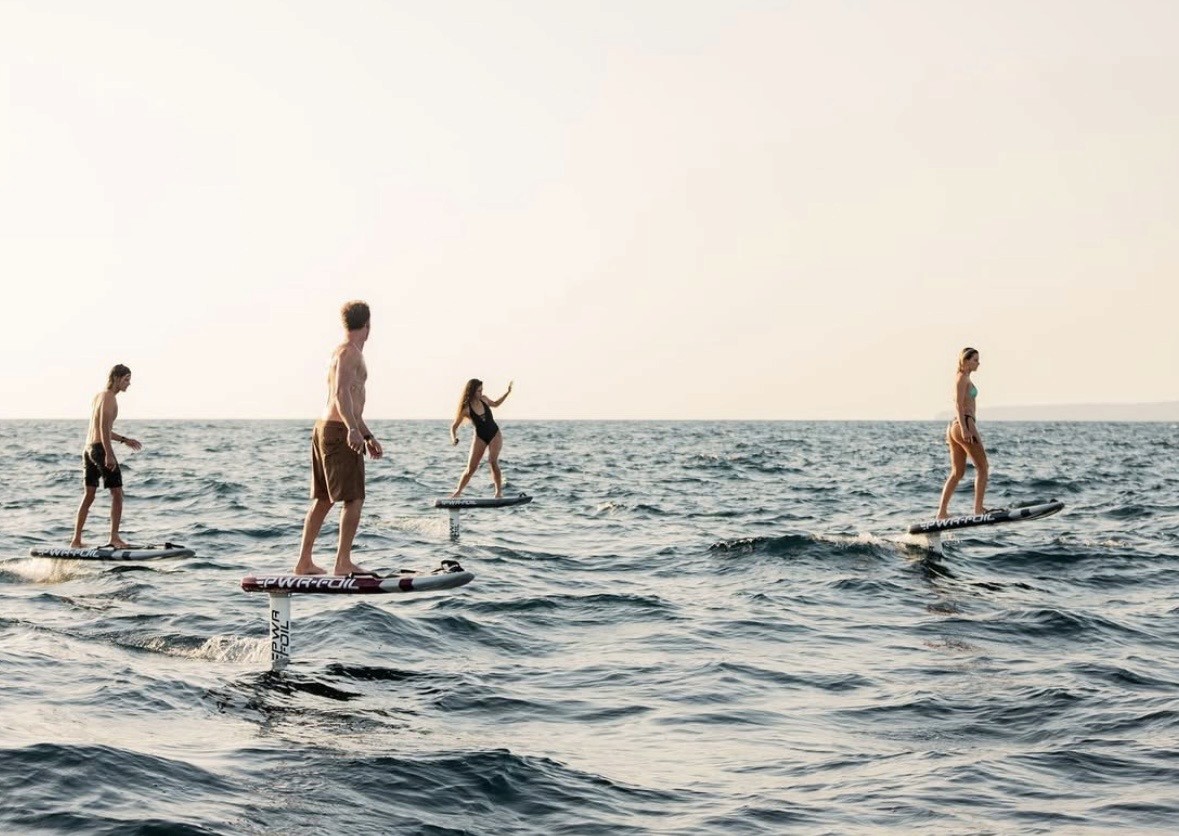 A man standing with Sufboard