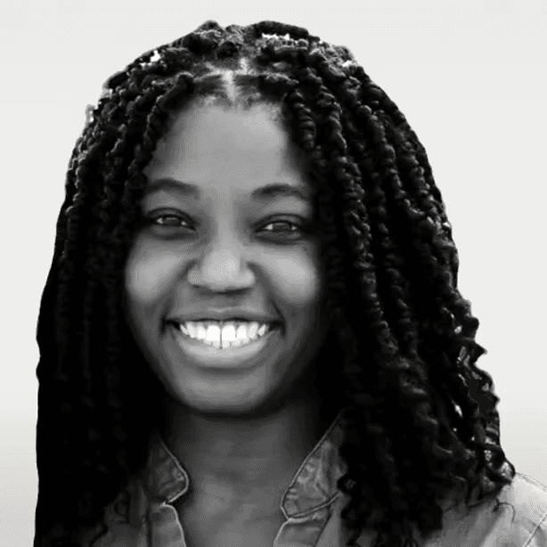 Young man with red hair, freckles, tweed jacket, and silk scarf.