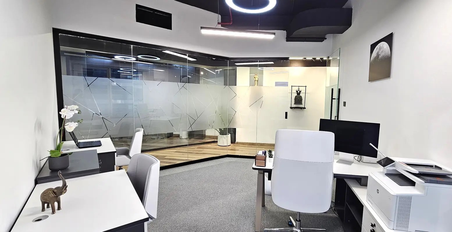 Spacious open-plan corporate office layout with modern lighting and high-quality office equipment.