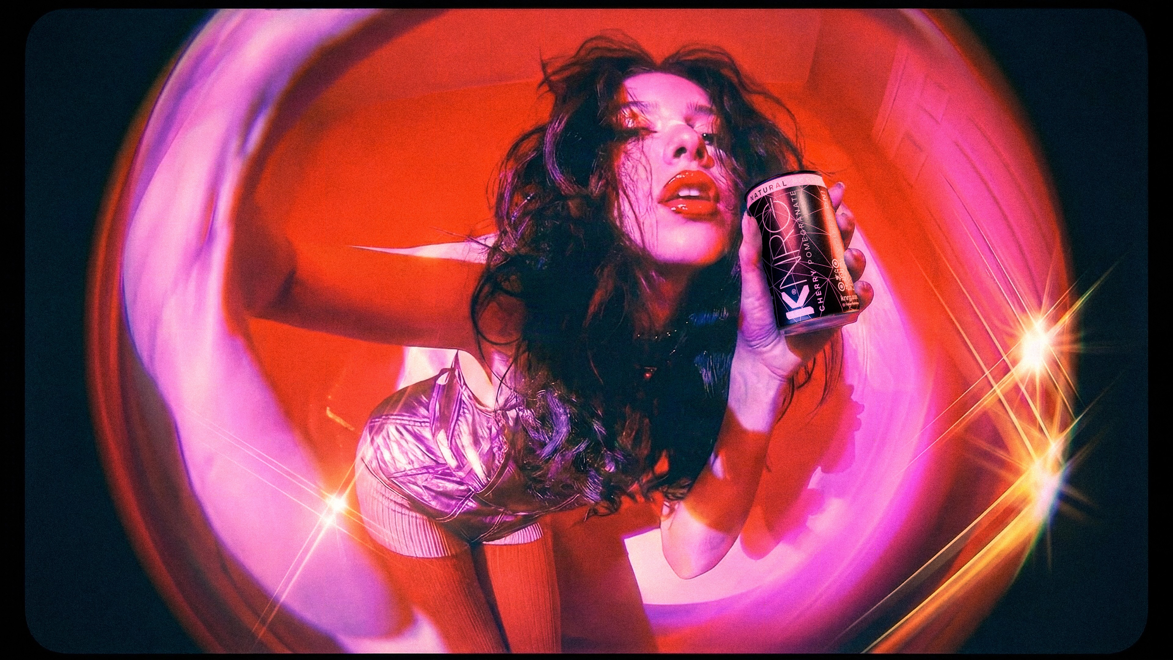 KNRG cherry can in a stylised pink portrait.