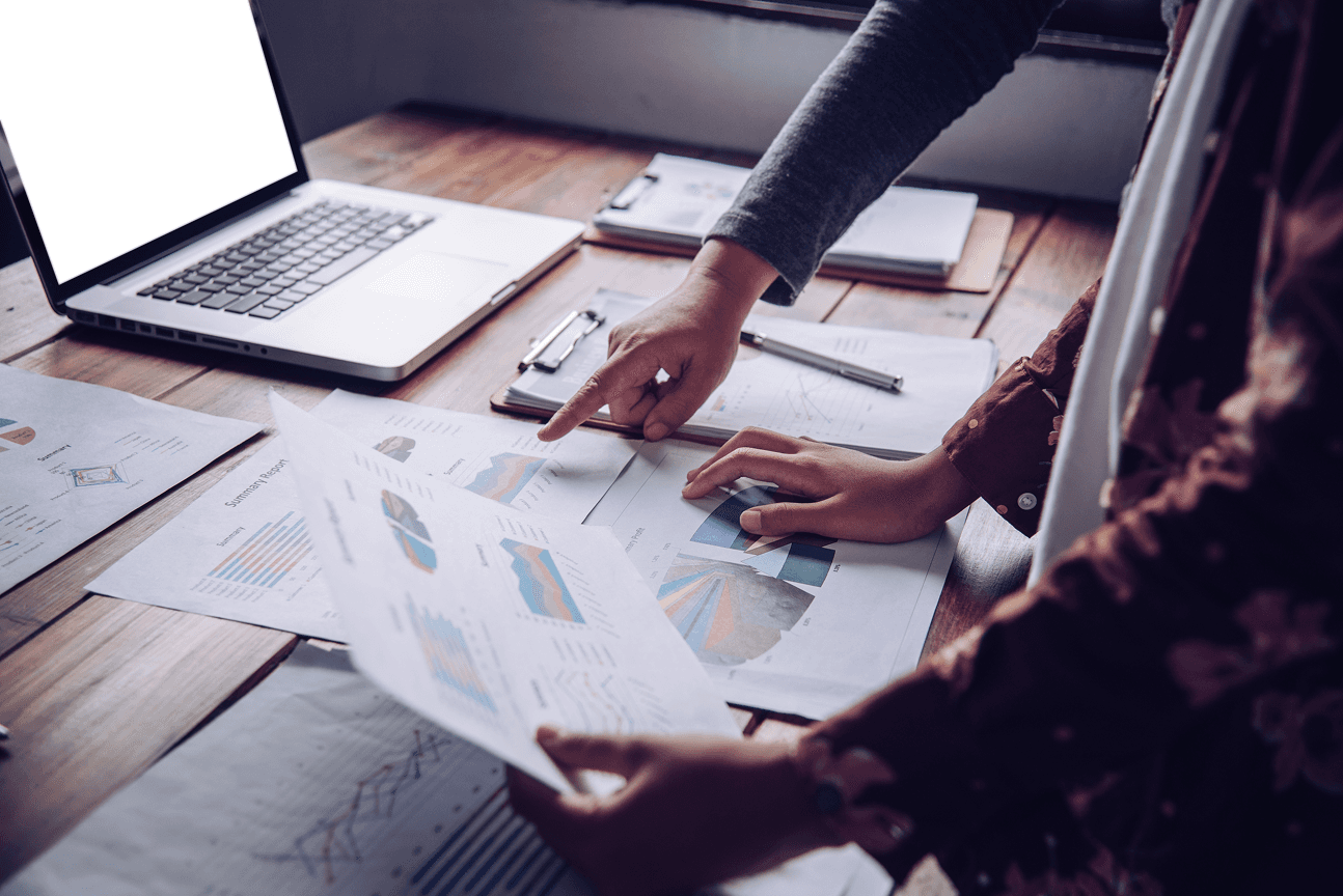 person touching and pointing MacBook Pro