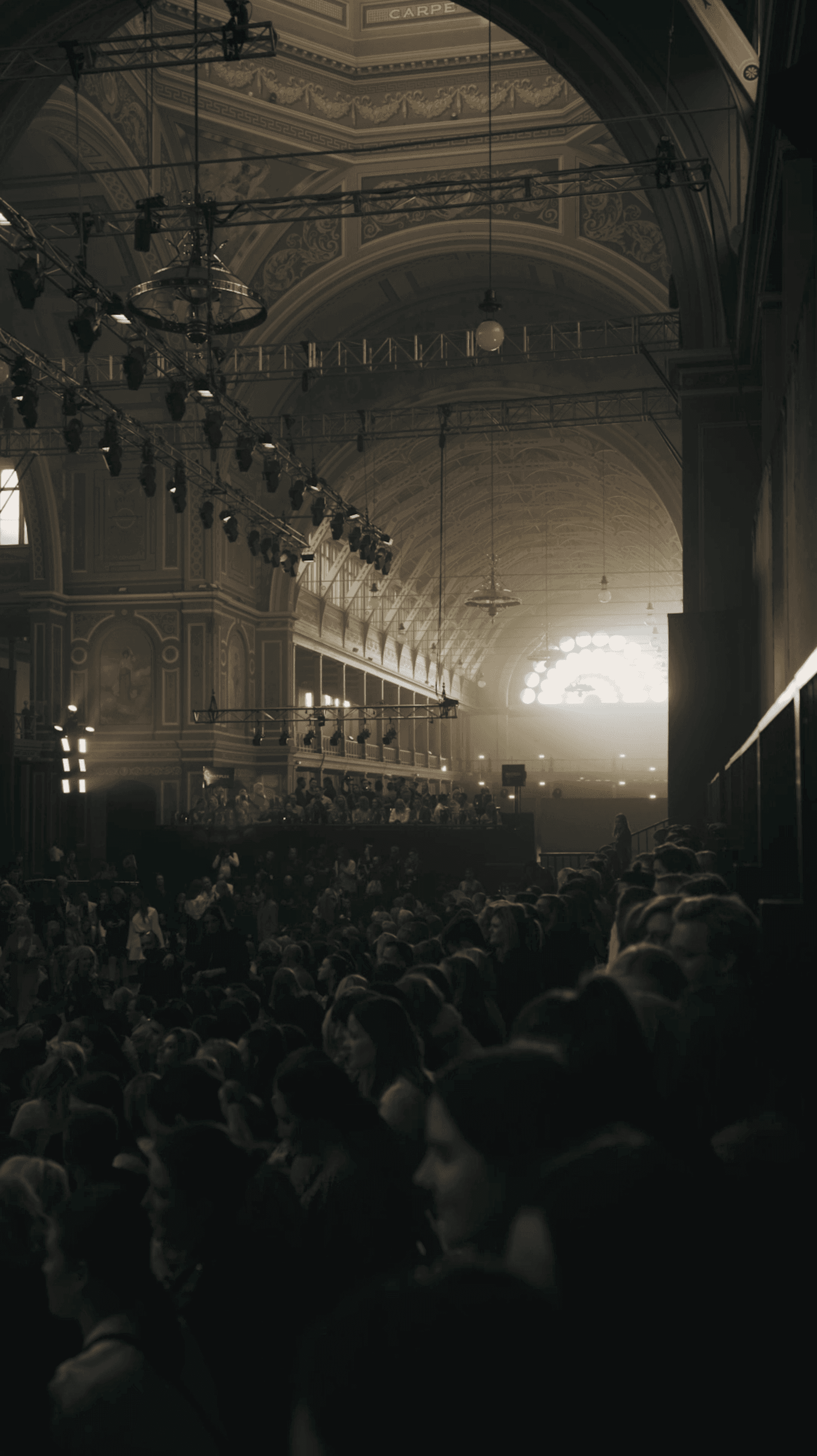 Interior of a dimly lit auditorium or theater with rows of seats