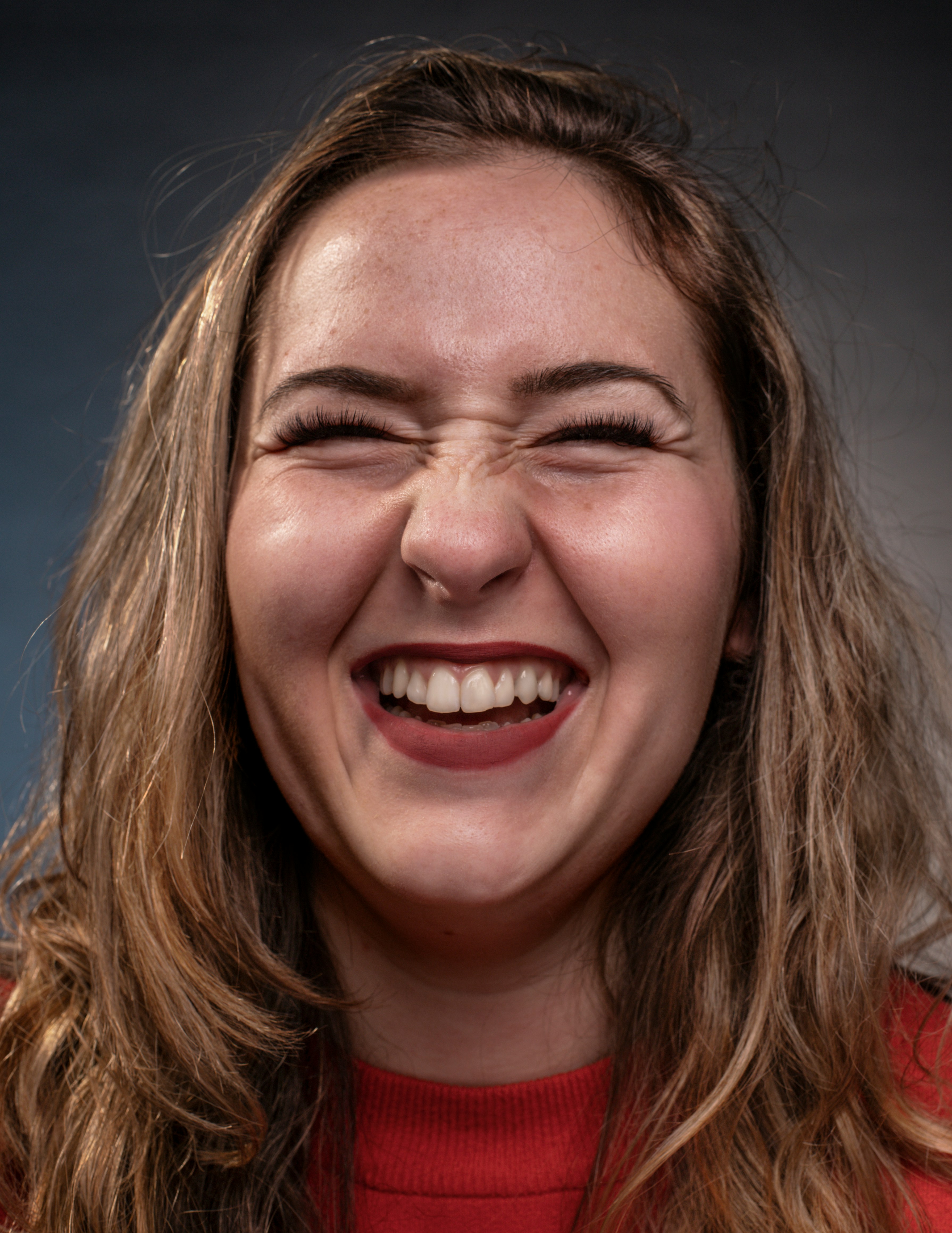 a woman smiling with a toothbrush in her mouth