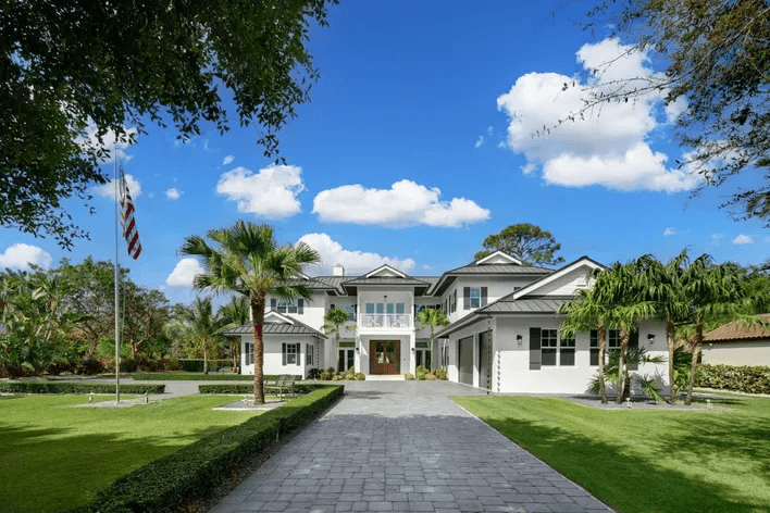 A Miami White Home with an american flag on the outside