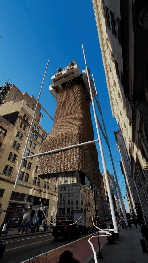 A skyscraper draped in a massive knitted brown sweater under a clear blue sky
