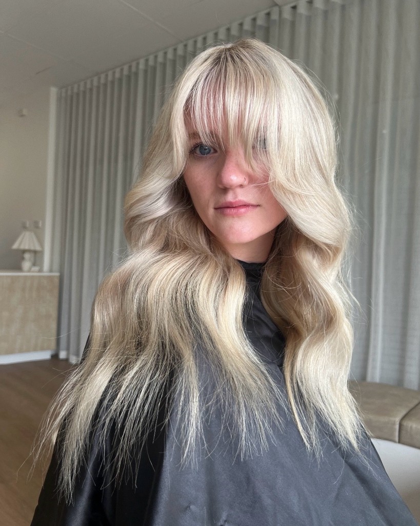 Model with blonde hair with a bit of colour and a gorgeous fringe done by Goldi