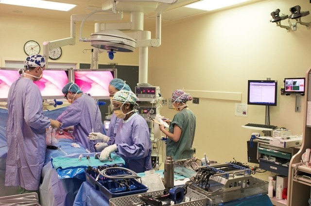 Surgical staff operating on a patient in an OR