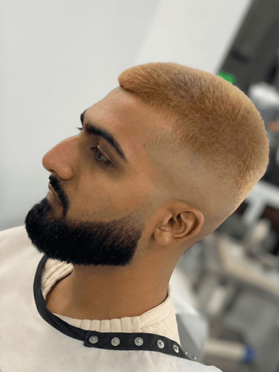 person holding white and gold hair comb