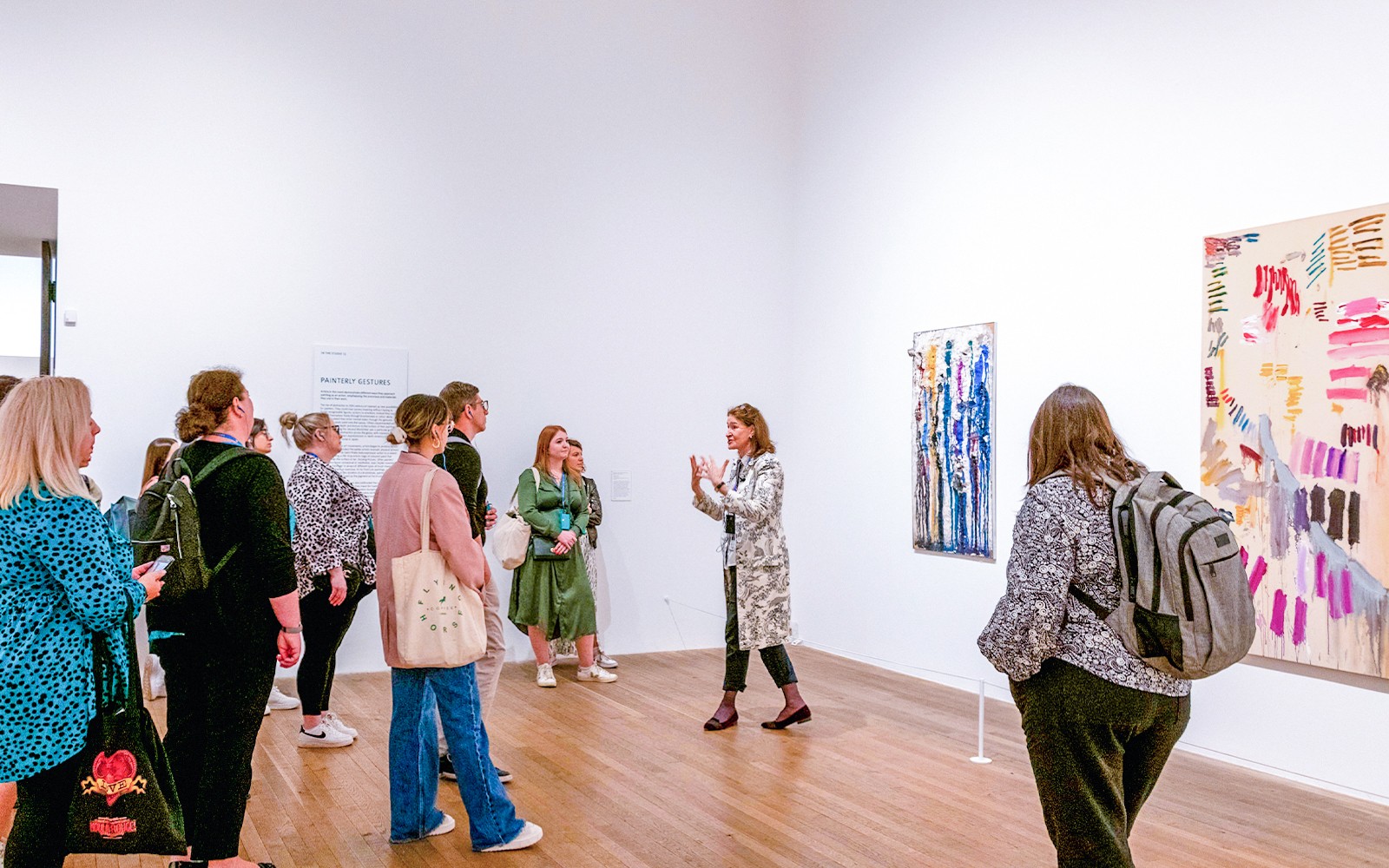 Group listening to a guide inside Tate Modern gallery.