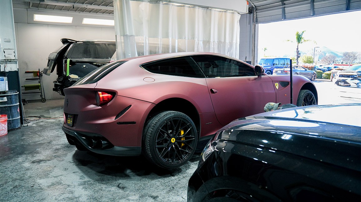 Ferrari inside Auto Body Unlimited’s facility during insured collision repair process.