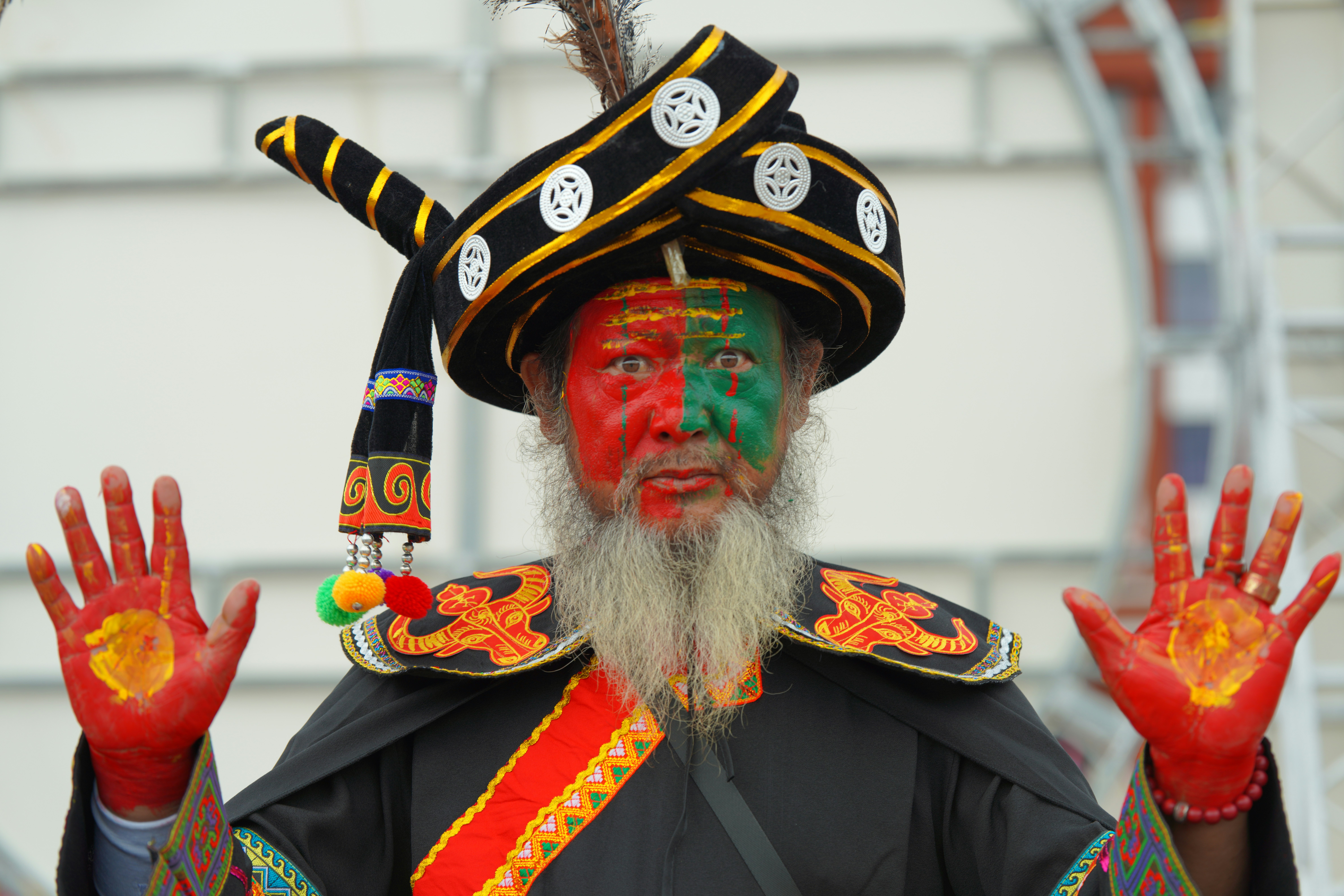 Man with painted face and outstretched hands