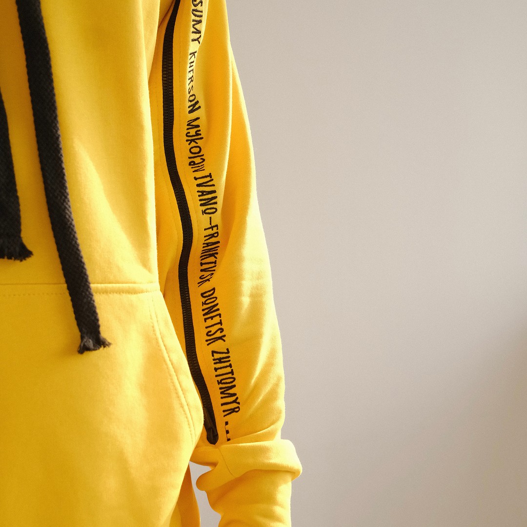 Modern home office setup with a monitor, ergonomic chair, keyboard, and indoor plants near a window with blinds.