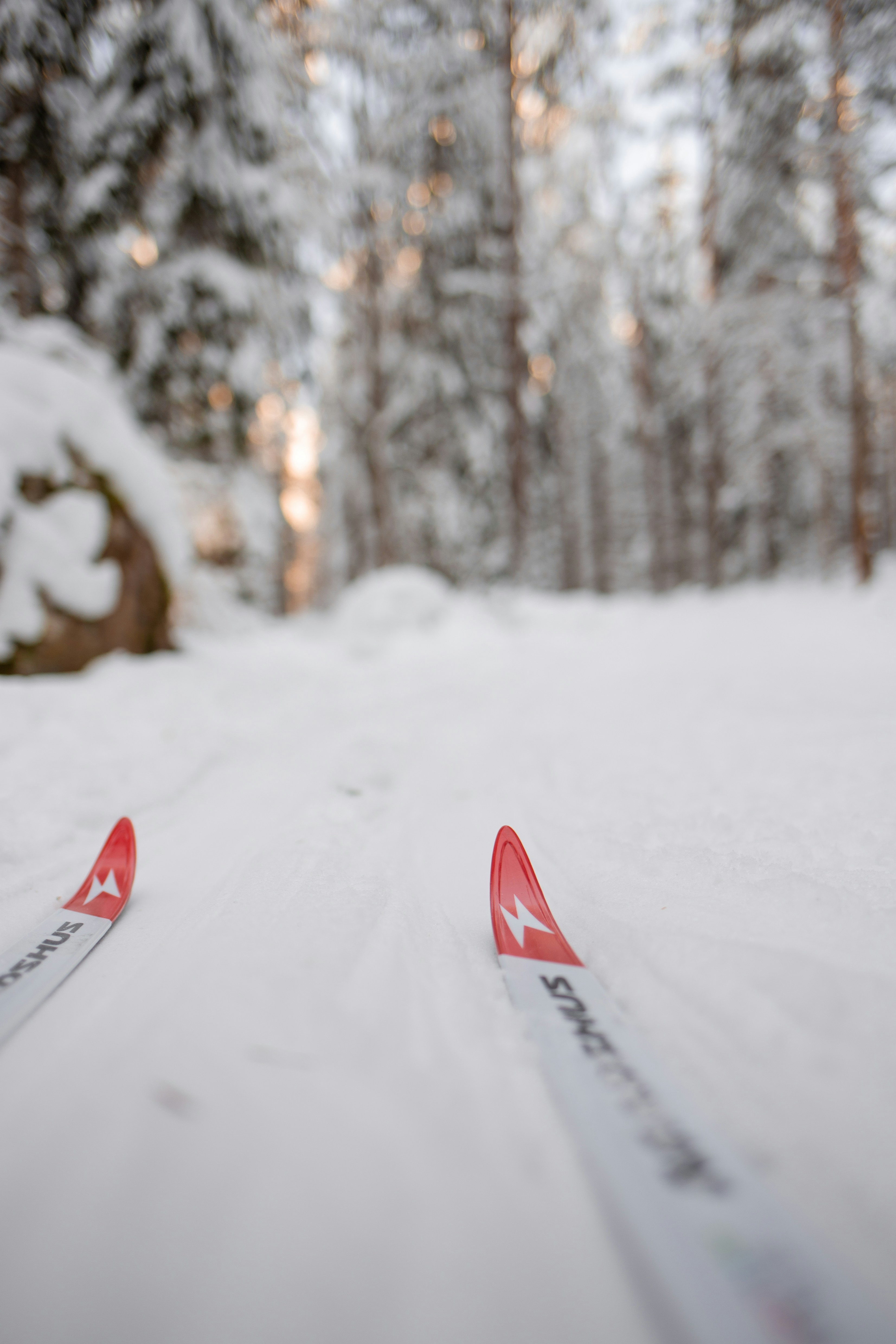 A pair of skis sitting on top of a snow covered slope