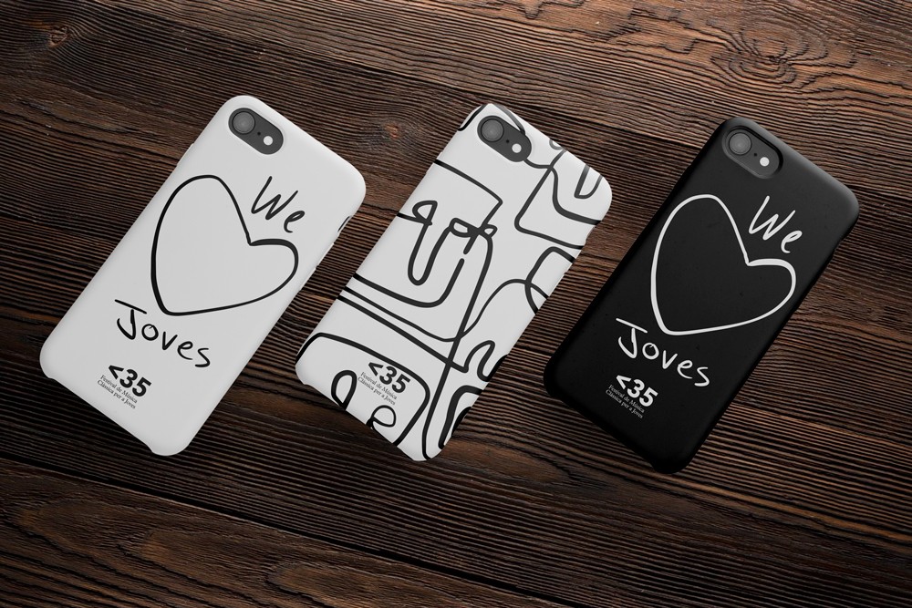 Two phone cases featuring bold black and white Less Than 35 graphic illustrations laid on a dark wooden surface, showing the brand identity applied to merchandise.