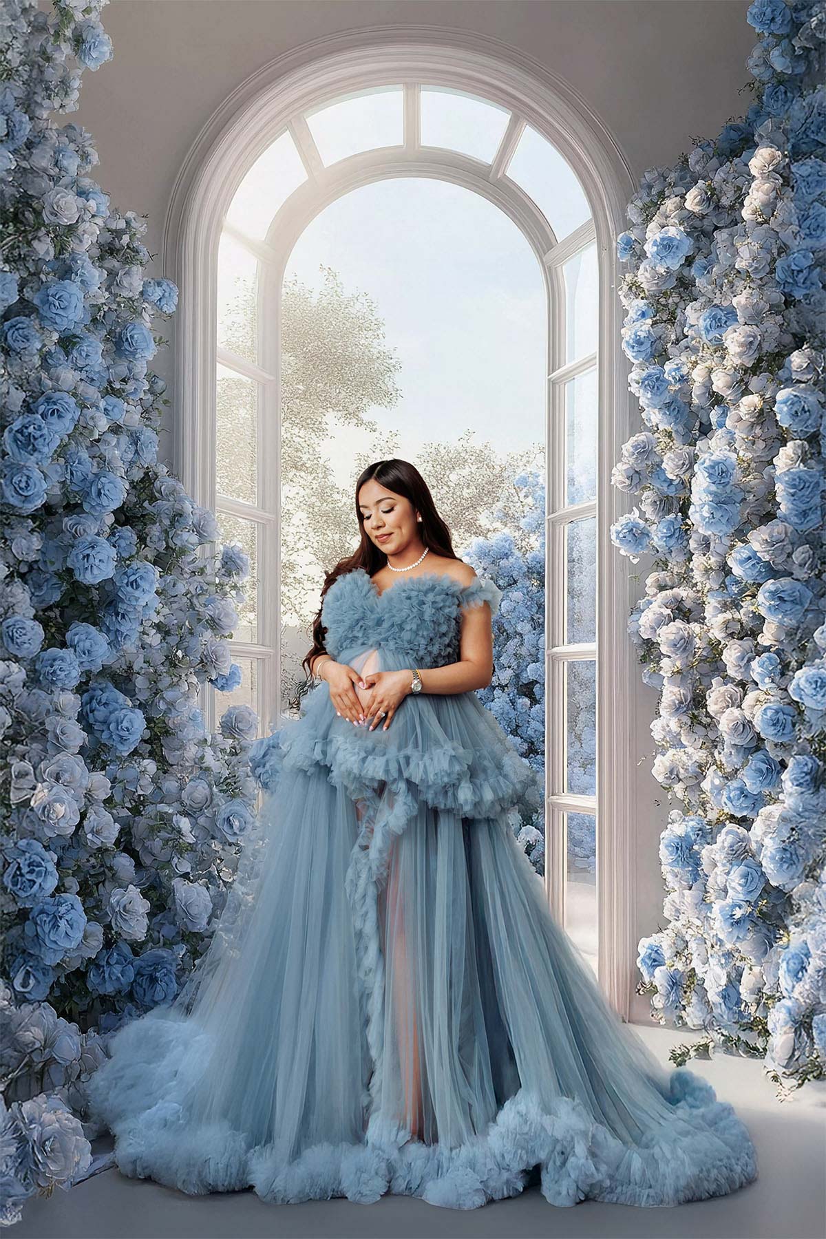 Studio maternity photography featuring delicate fabric and artistic mood.