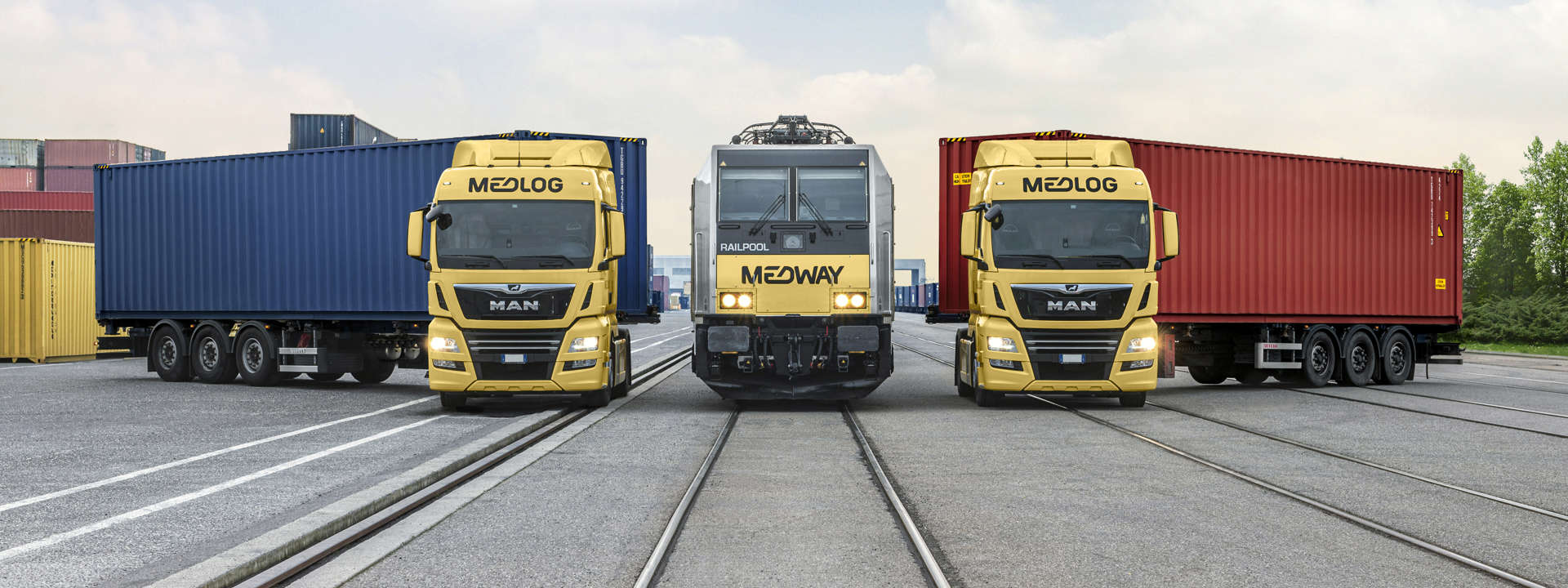 Medlog and Maritime Transport trucks parked side by side, representing the integration of UK and European logistics networks