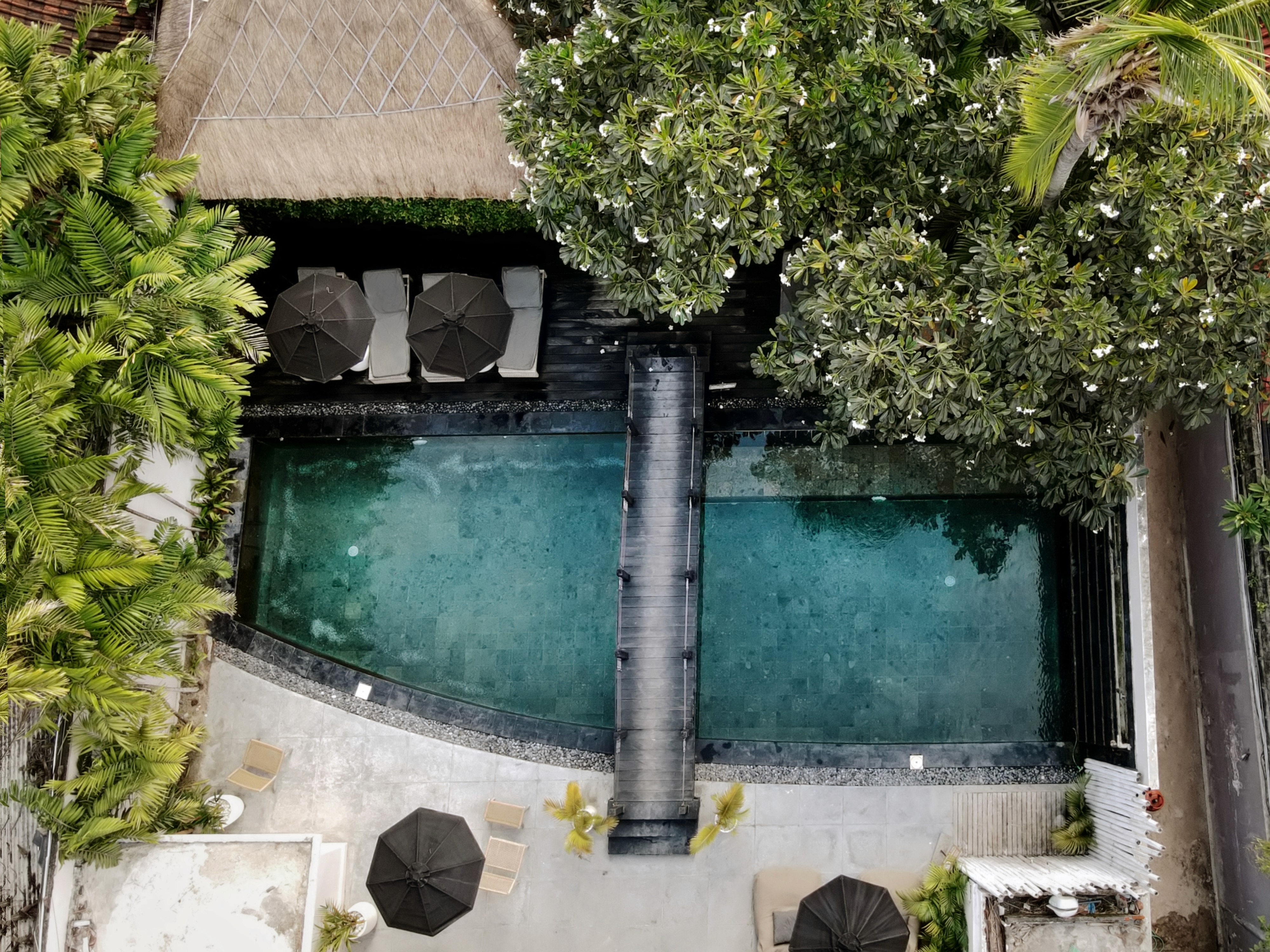 Aerial drone view of Indiana Kenanga hotel pool, Nusa Lembongan Indonesia