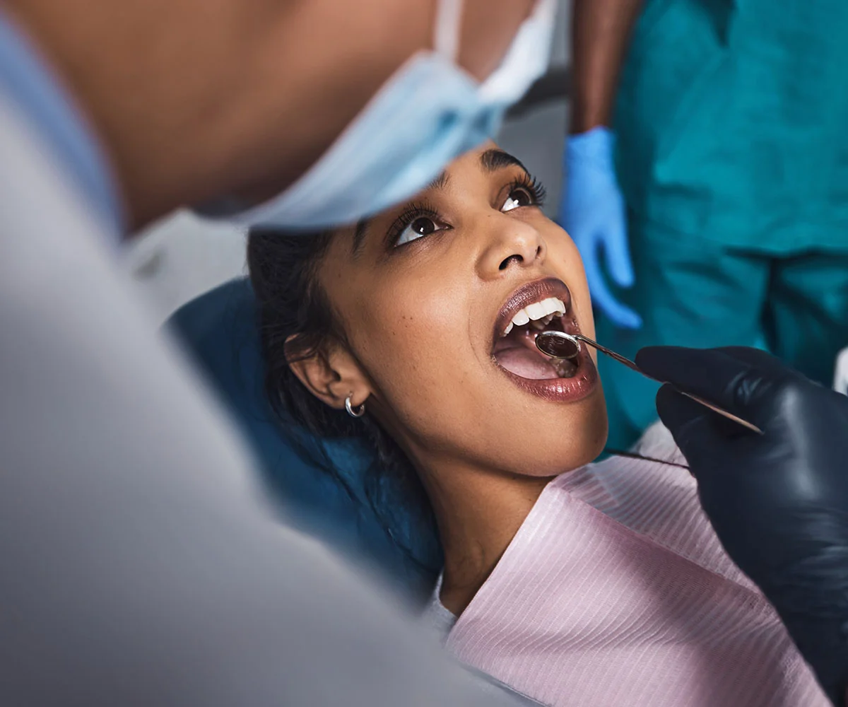 Patient receiving an oral examination during a comfortable and personalized dental surgery appointment.