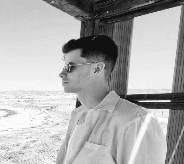 Man wearing sunglasses overlooking the ocean