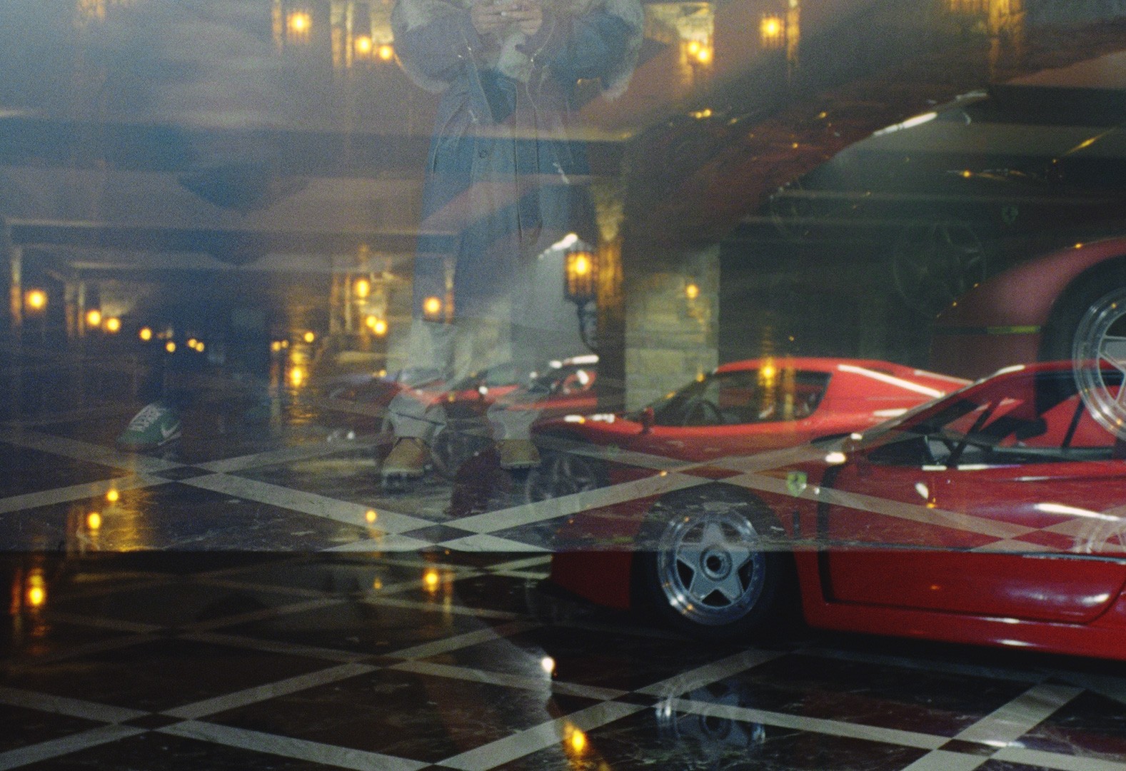 Close-up detail shot of a red Ferrari LaFerrari on checkered marble flooring, graded for a Drake ICEMAN music video