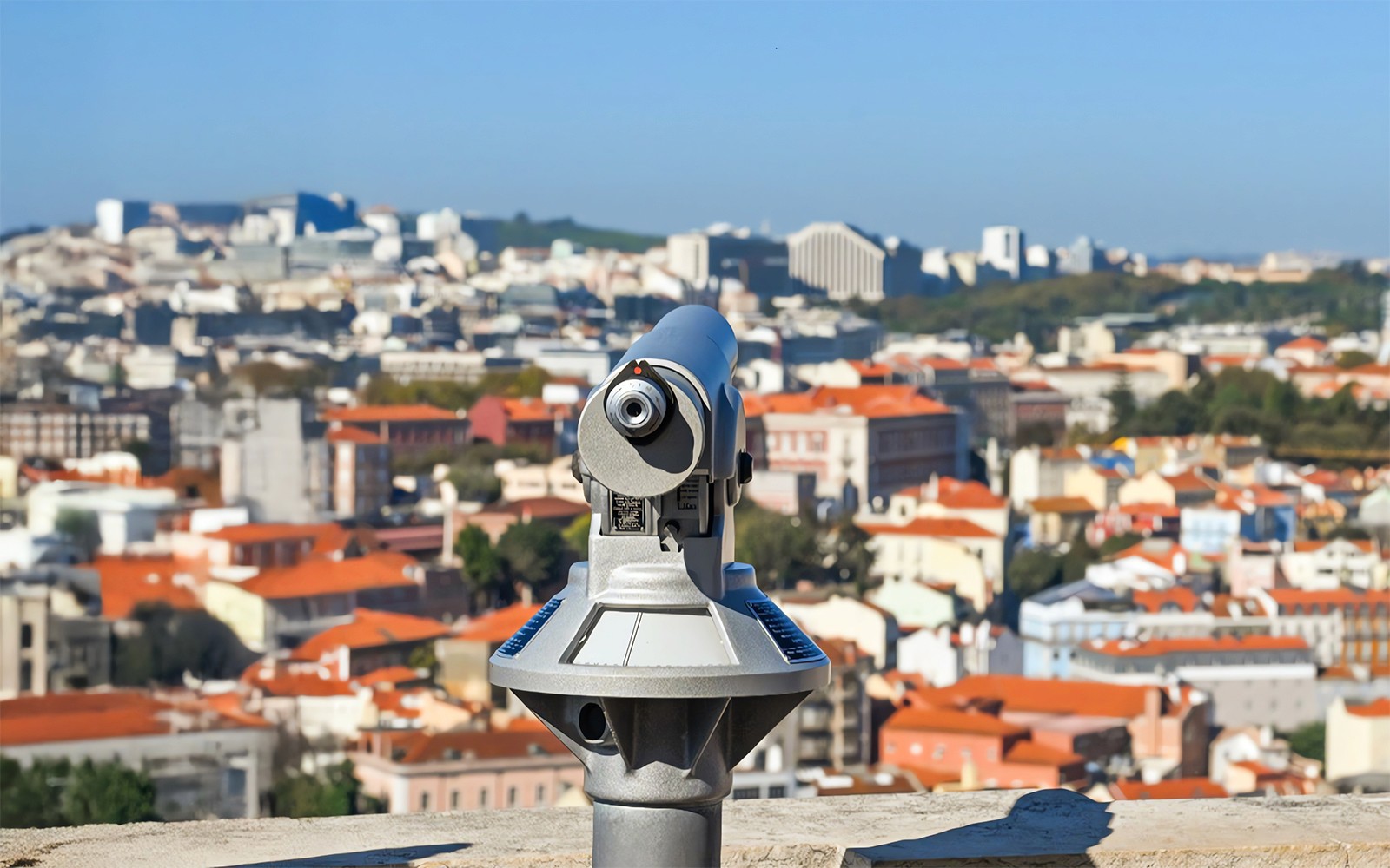 Telescope on Church of Graca terrace overlooking Lisbon cityscape.
