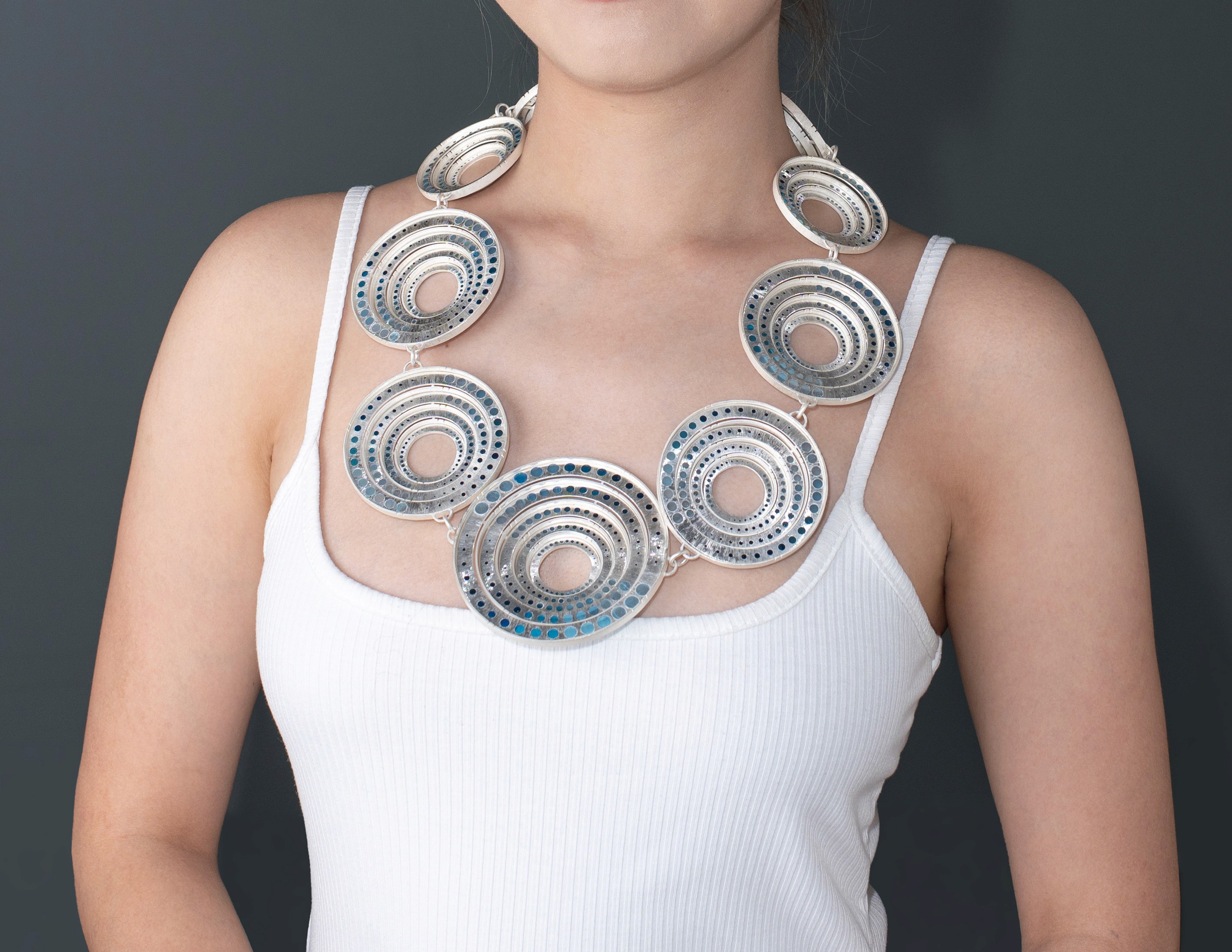 Ripple by Yuxin Song worn on model, plique-à-jour enamel on silver. Contemporary jewelry art, 26 x 30 x 3cm, 2025. Masterpiece of translucent enameling technique.