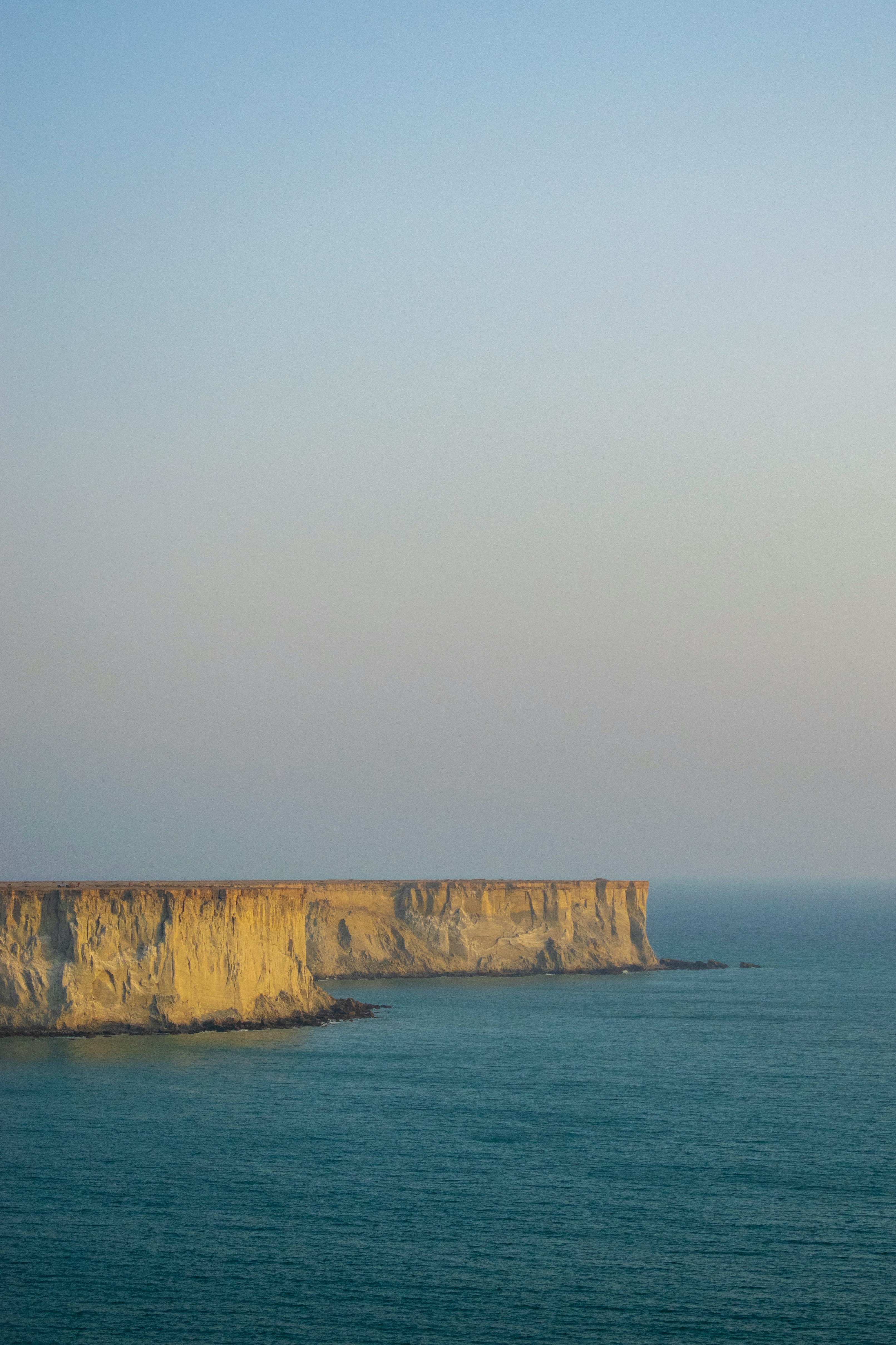 a large body of water sitting next to a cliff