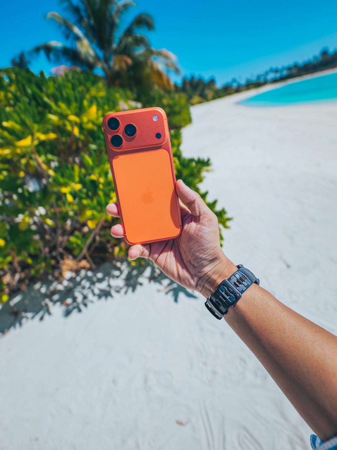 Portrait of a red-haired woman with freckles posing by the sea.
