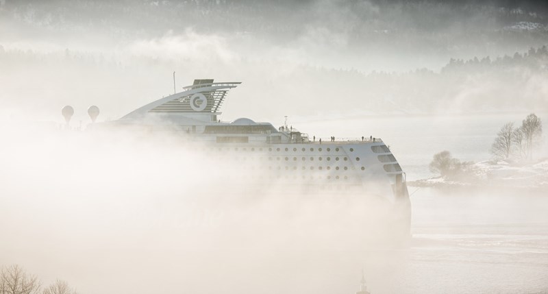 Cruise ship on water with fog