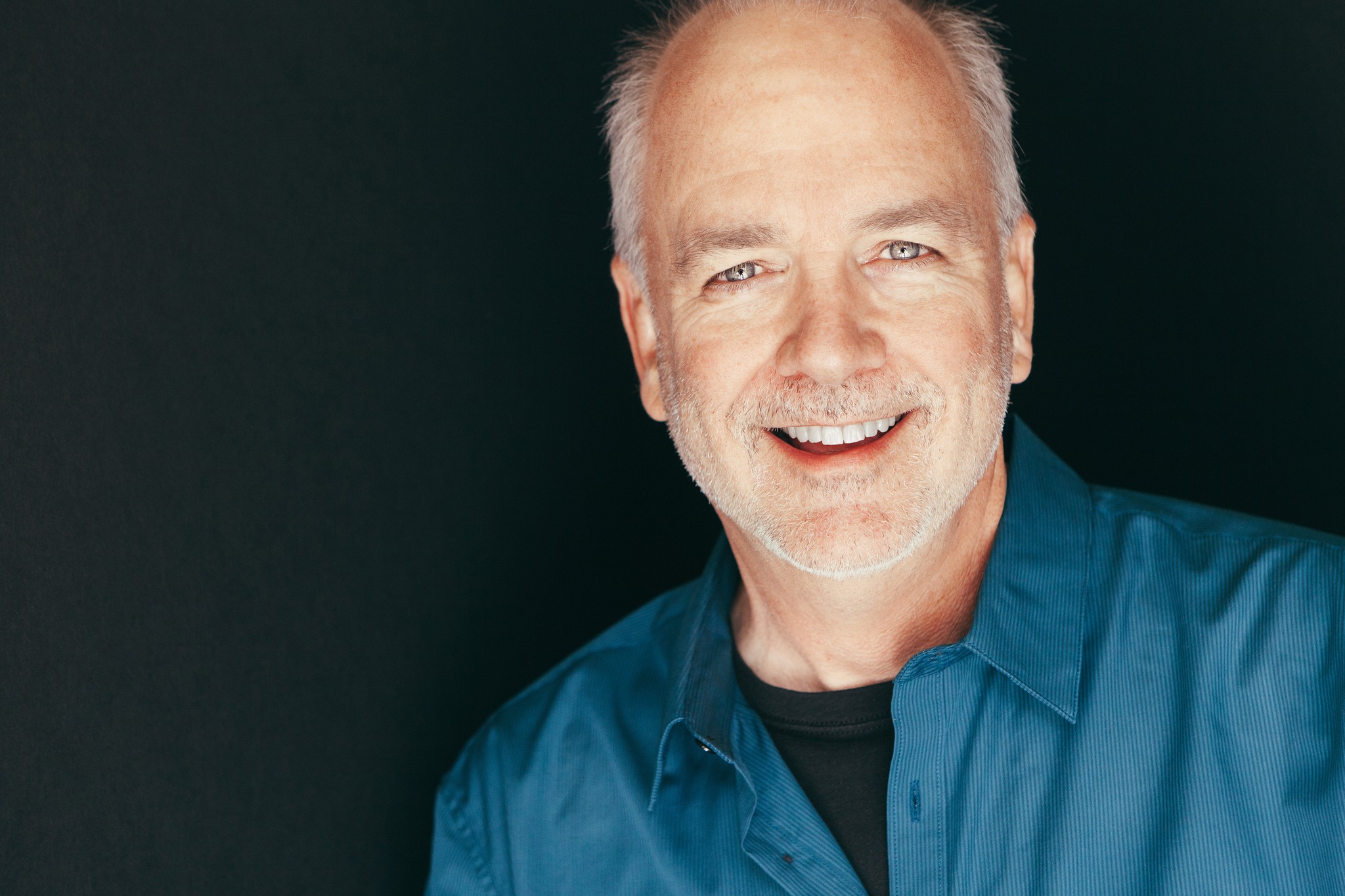 Executive branding portrait of songwriter Byron Hill, photographed in his garage using natural light with subtle fill flash.