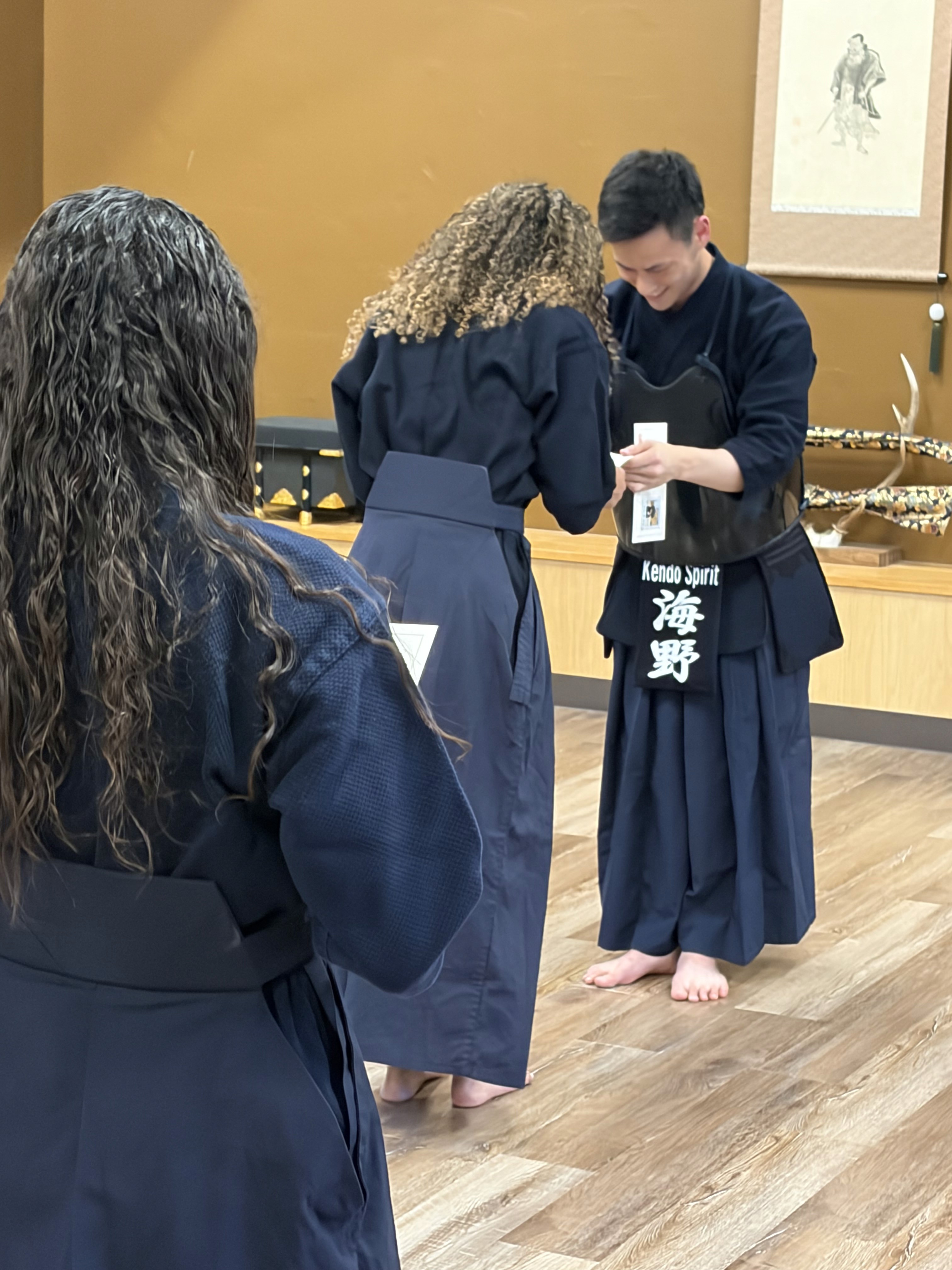 Young adult learning Kendo in a Japanese dojo