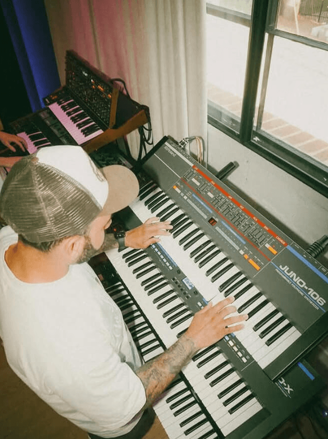 man playing a synthesizer
