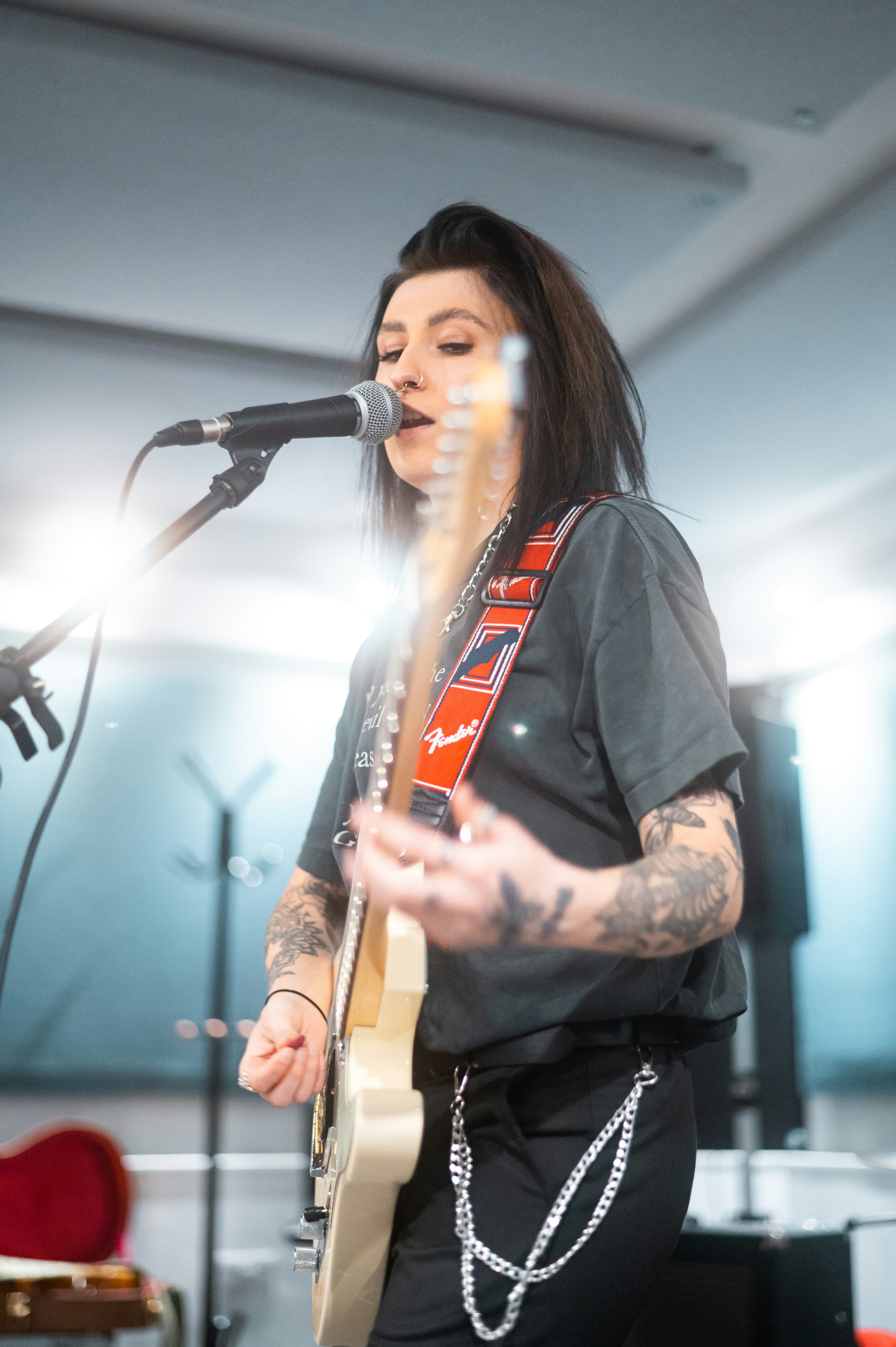 girl playing guitar and singing