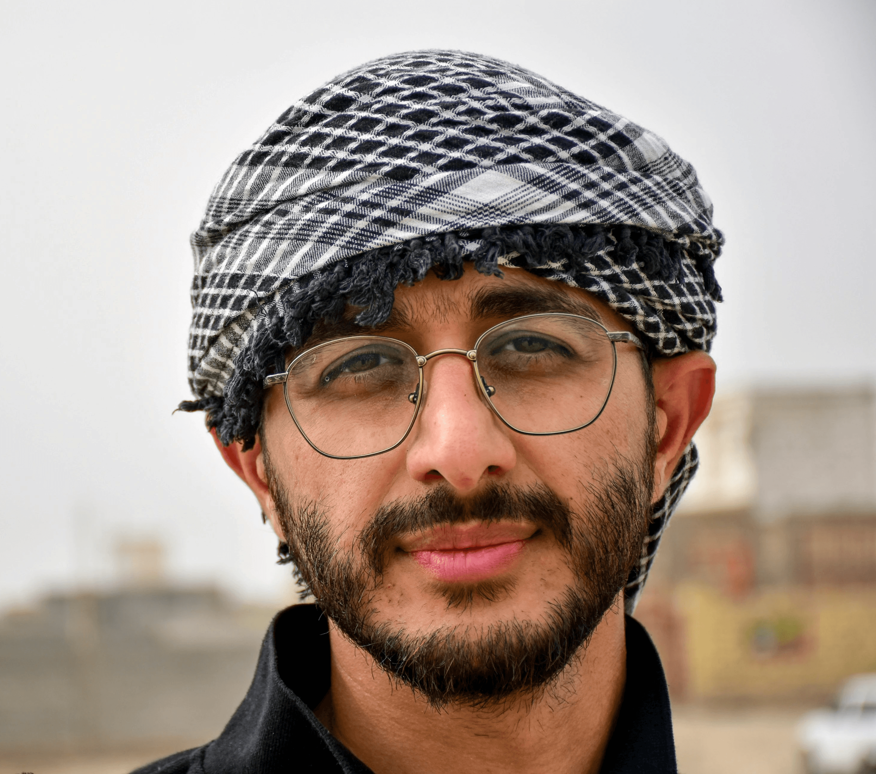 man in black and white knit cap and black framed eyeglasses