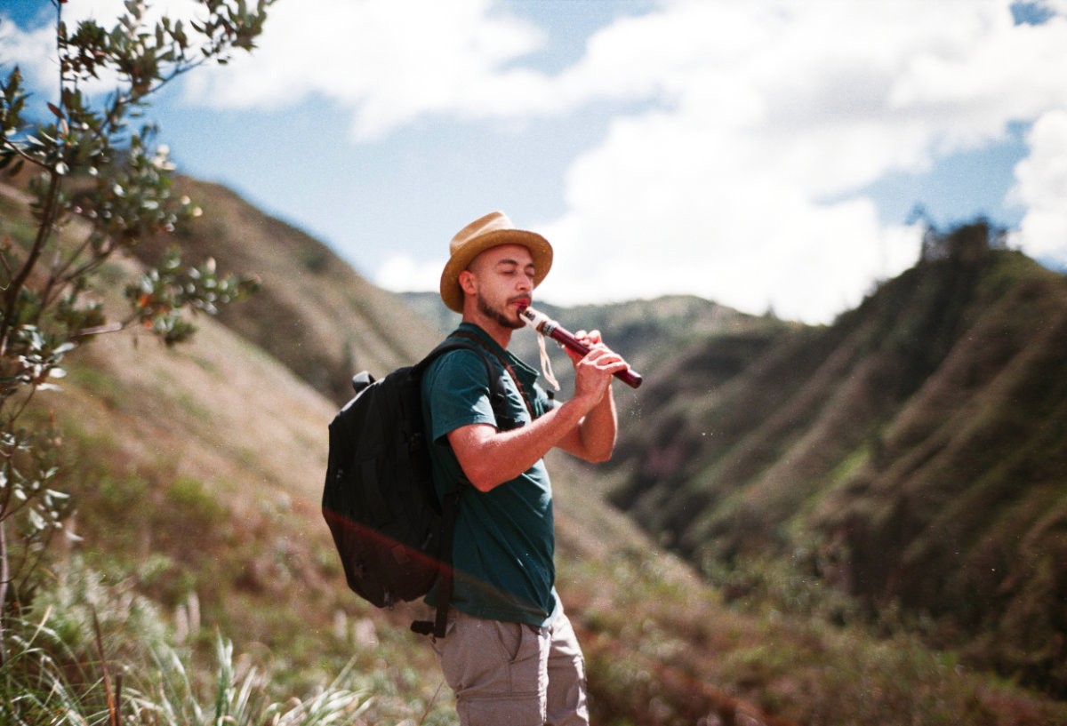 Person playing flute during ayuhuaska retreat in Ecuador