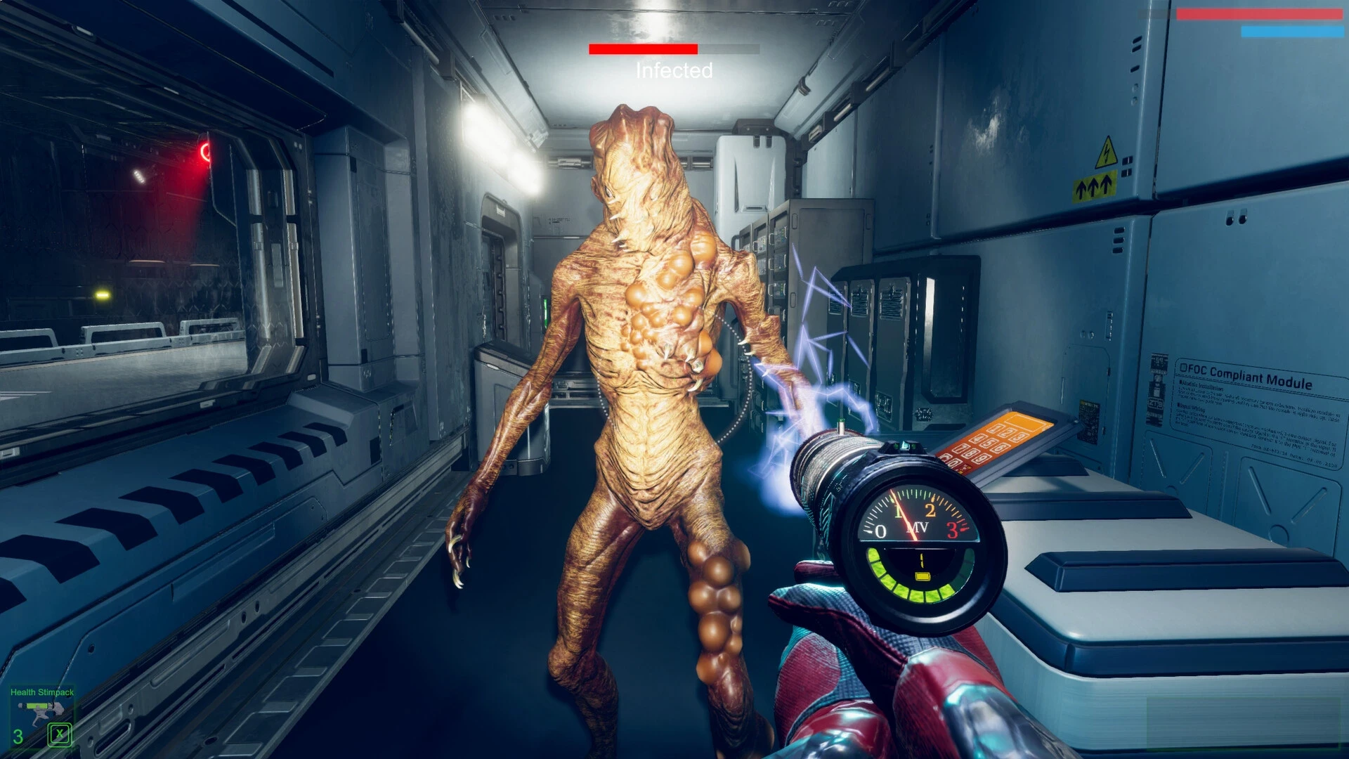 A futuristic first-person perspective depicts a player inside a spaceship corridor confronting a humanoid alien creature, using a glowing high-tech weapon to attack in the dimly lit, metallic interior.