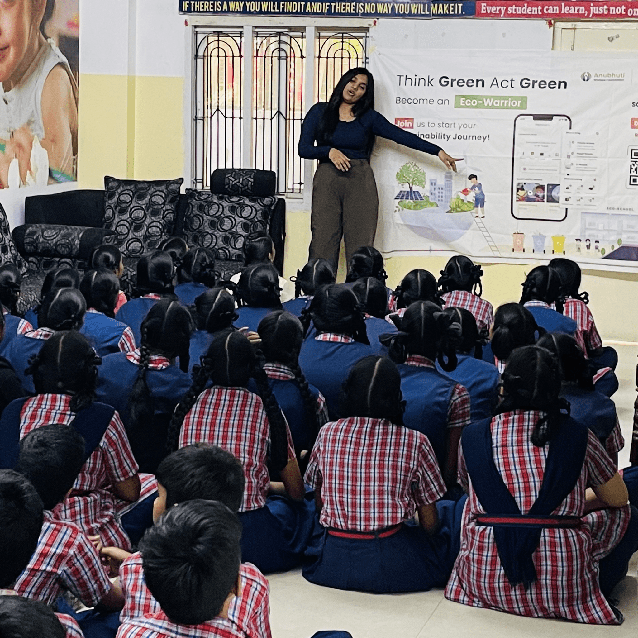 Woman in red outfit poses by a red telephone booth.