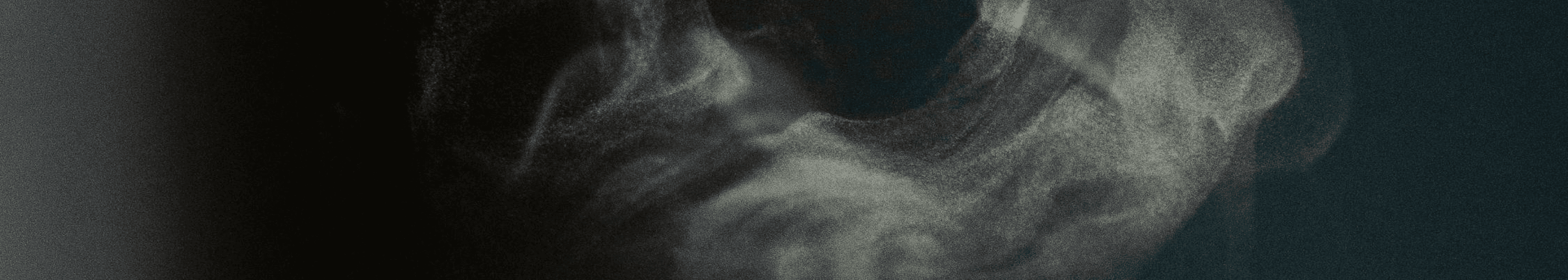 Gun smoke or coffee steam on a grainy, dark background