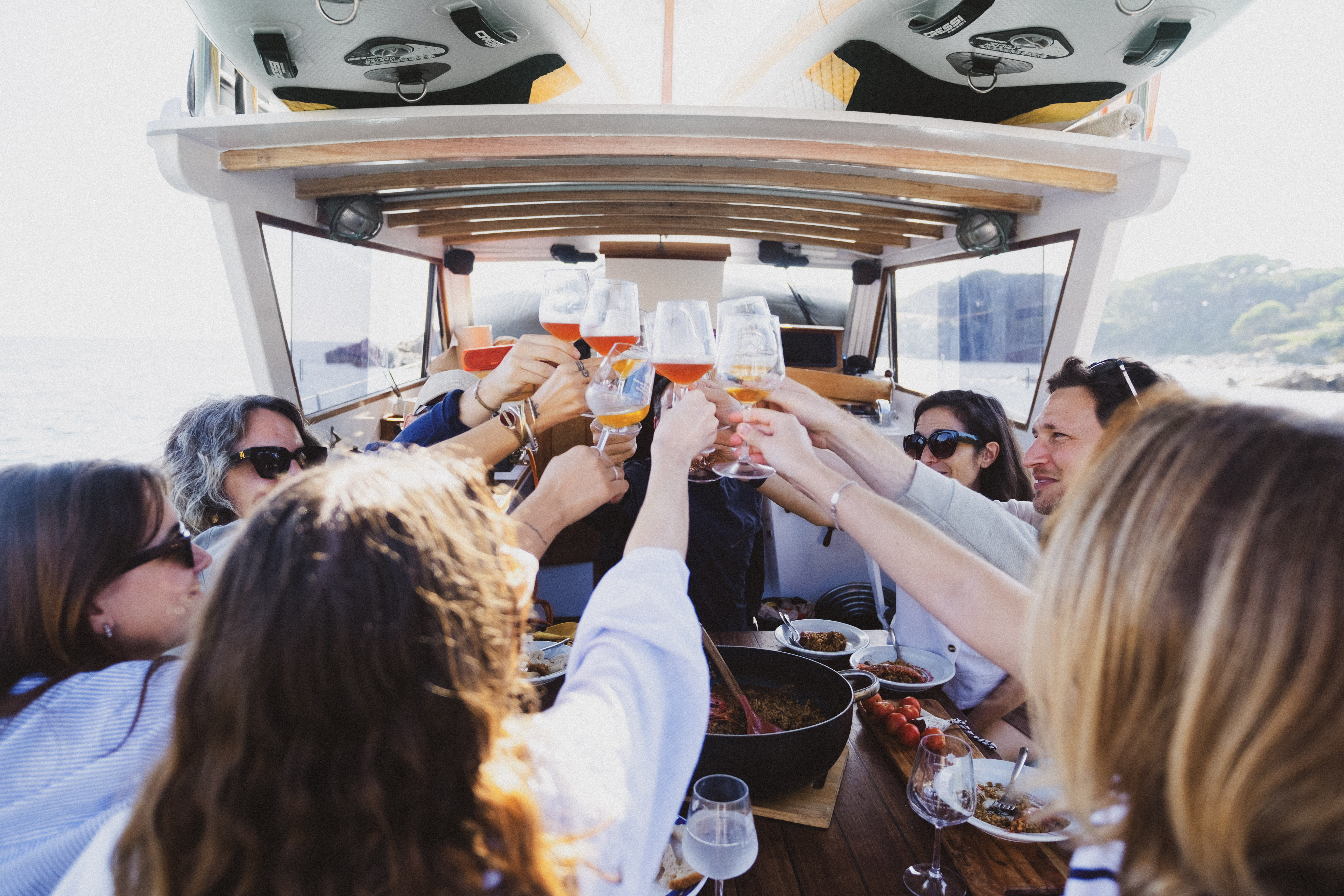 Adler & Marlow team having lunch and raising their glasses to make a toast