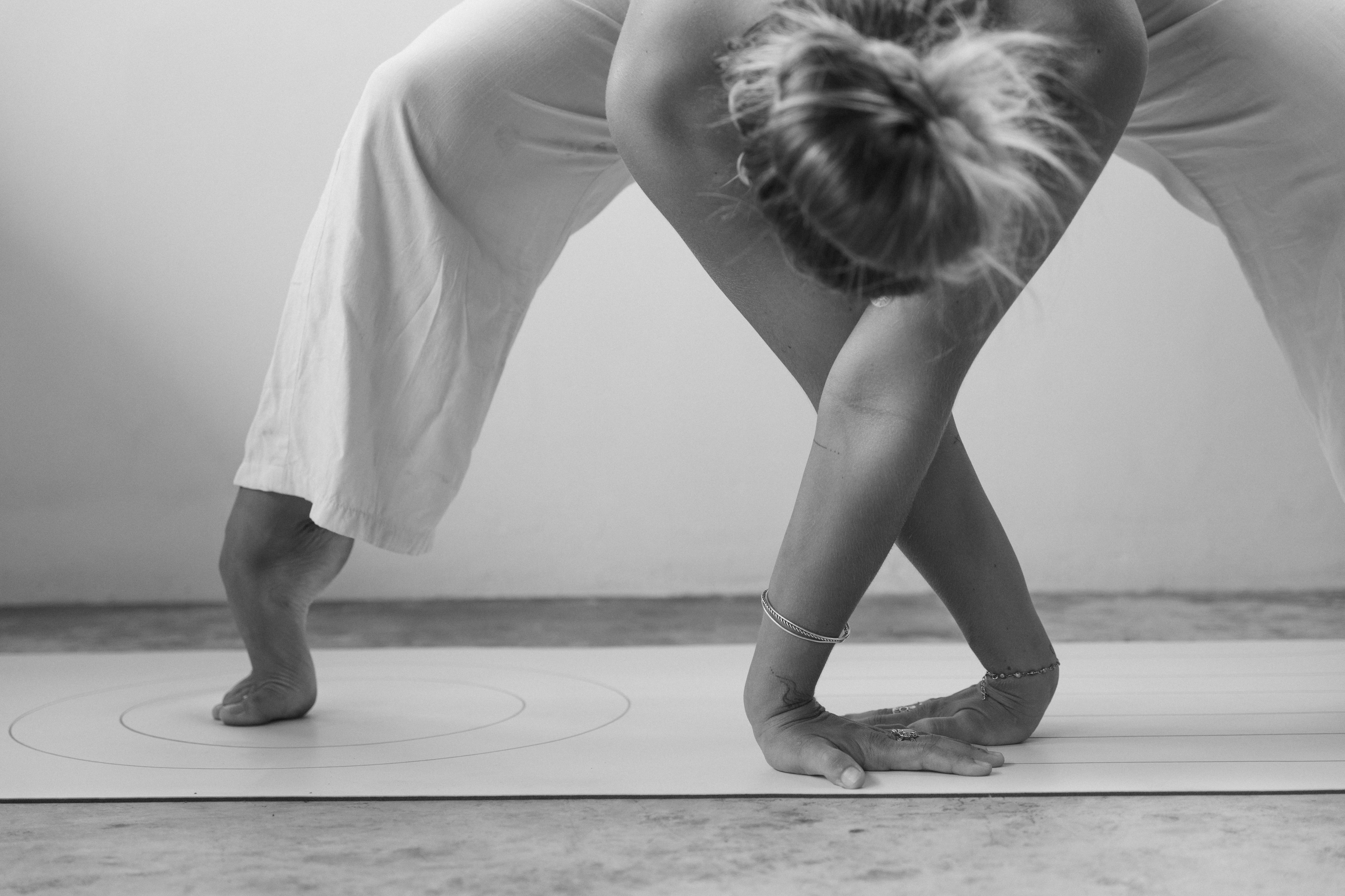 Girl laughing, getting sweapt away from a wave