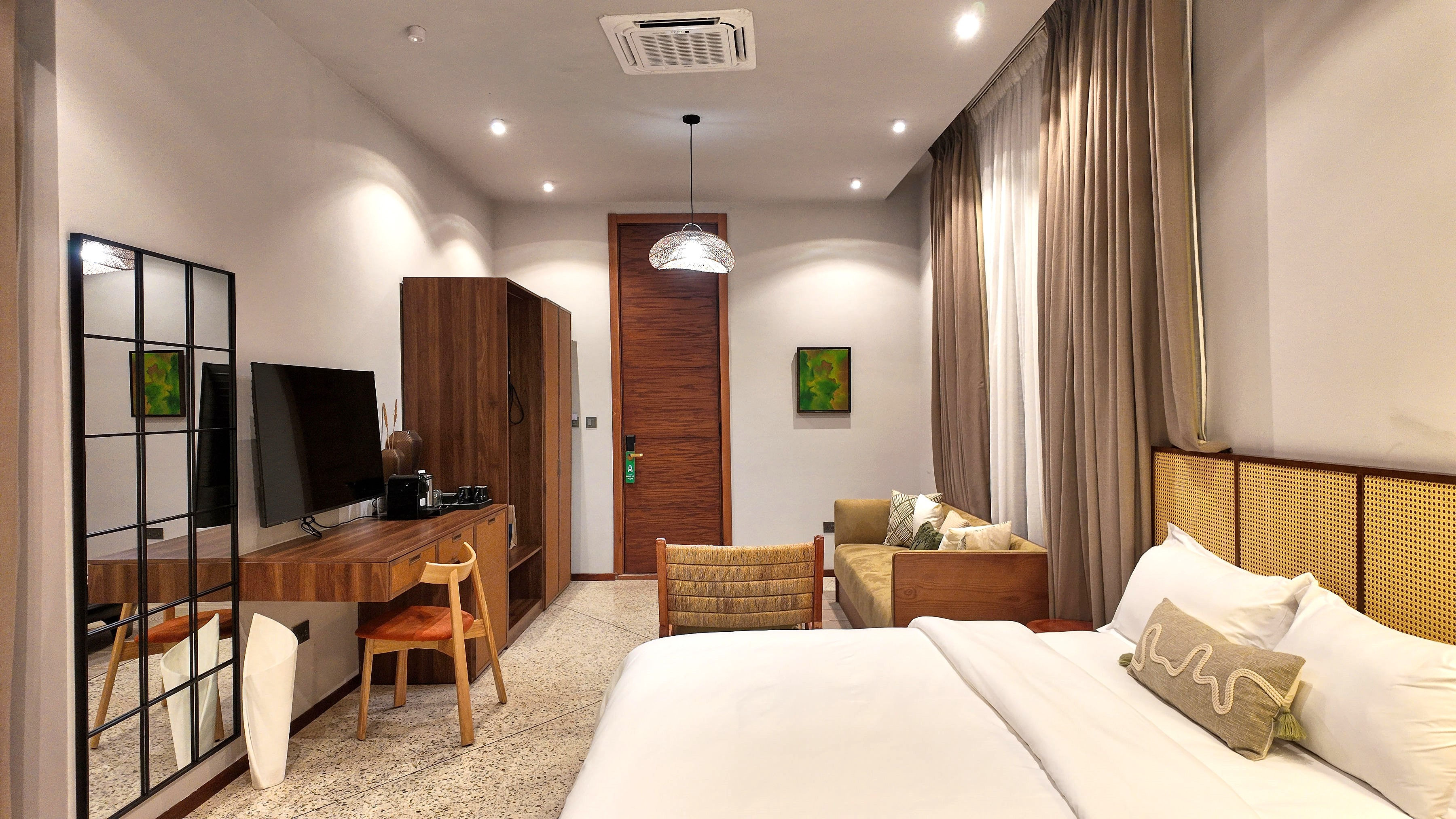 wide shot room with beds, desk, seating area